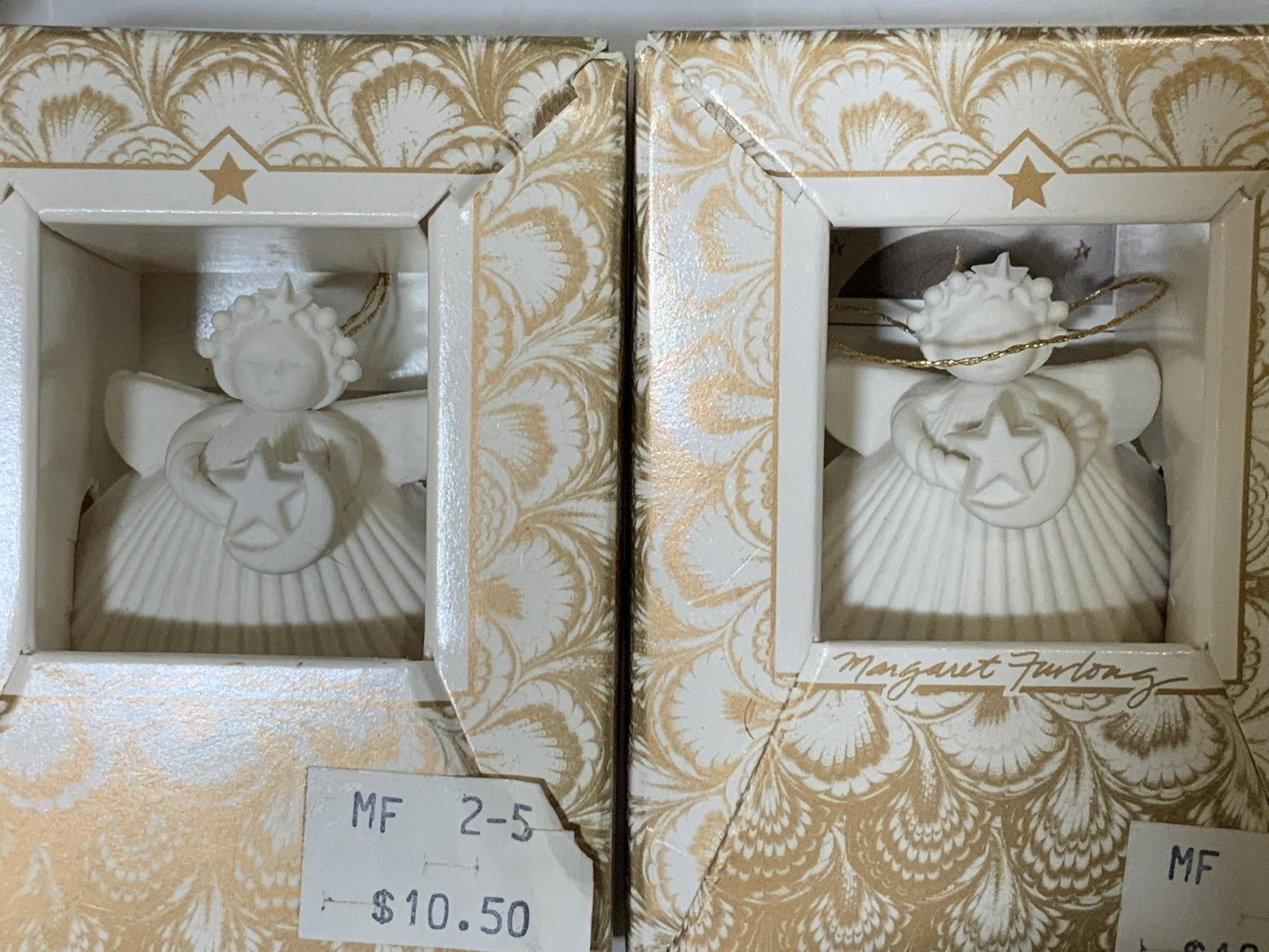 Set 13 Porcelain Angel Ornaments, M. Furlong: Never opened In Gift Boxes c. 1988 cream porcelain angel ornaments designed by Margaret Furlong, all by hand. Each Angel holds a different object- partridge, snowflake, cross, present, cross, etc. tot