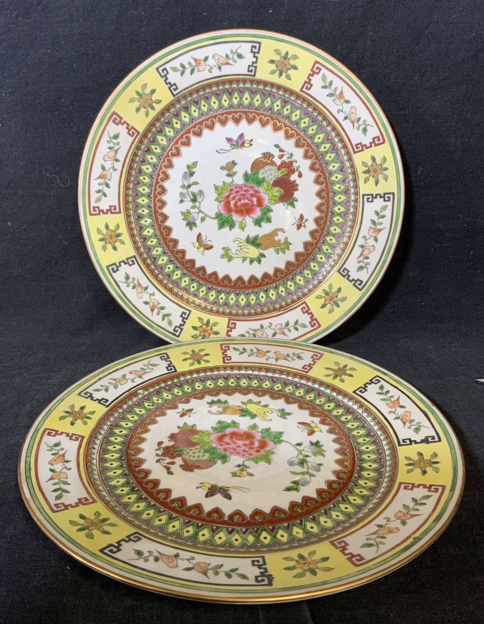 Pair Chinese Porcelain Plates: Pair Chinese Porcelain Plates, label to reverse of each reads ‘Made in China’, surface of plates decorated with geometric patterns and floral decor, both measure approximately 10.25 inches in diam