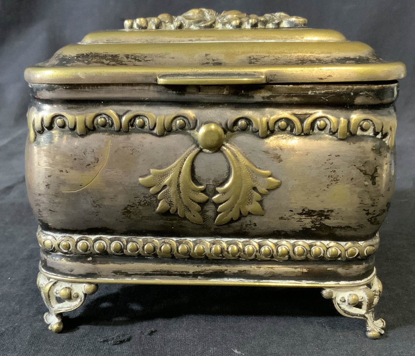 Vintage Silver Plated Sukkot Esrog Box: Silver plated esrog box, under side reads as FRAGET N PLAQUE. WEAR IS CONSISTENT WITH AGE AND USE. Decorated with floral, leaf and fruit detailing. Rests on four legs. Measures approx 4.25 inches h, 5