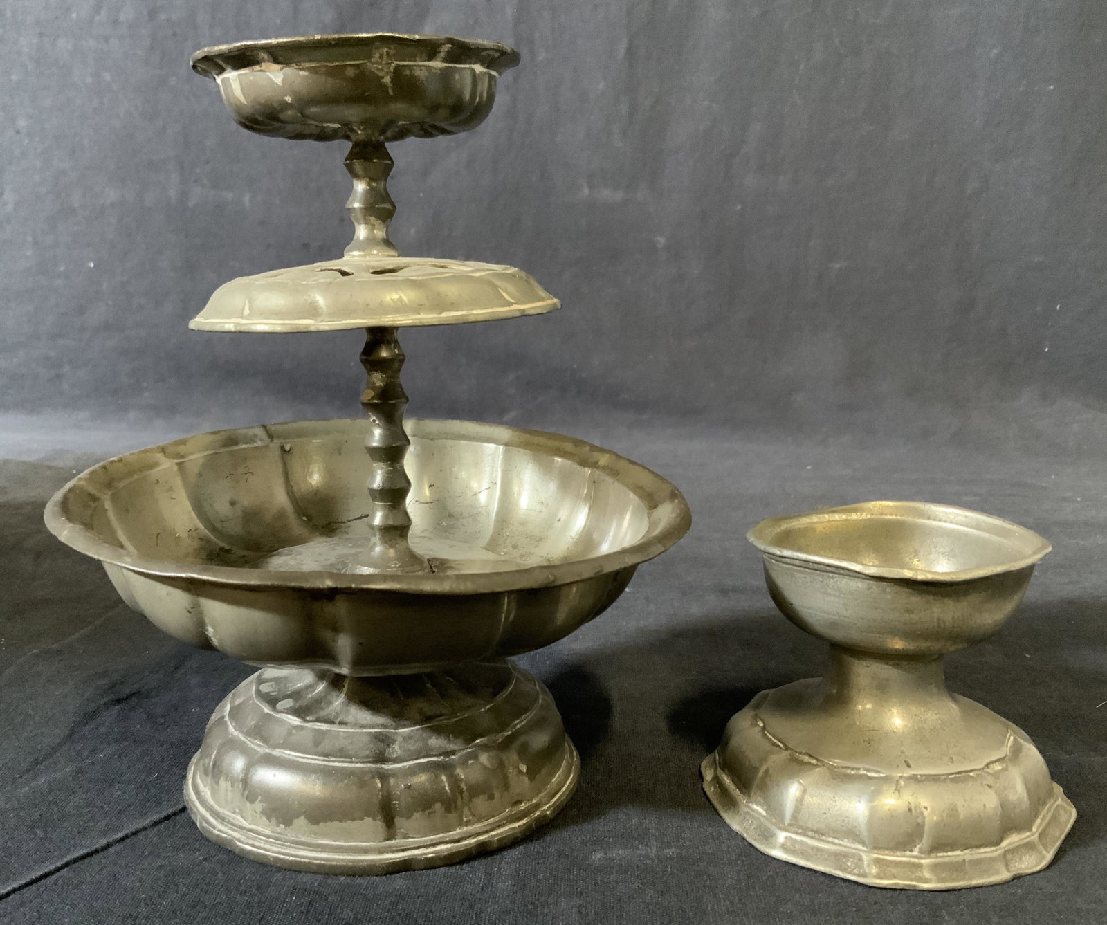 Lot 2 Pewter Decorative Accessories: Lot two vintage pewter accessories, possibly antique. Appear to be handmade, no apparent markings. Wear is consistent with age and use. Largest measures 6.75 inches h, 5.5 W. Pewter accessories, decor