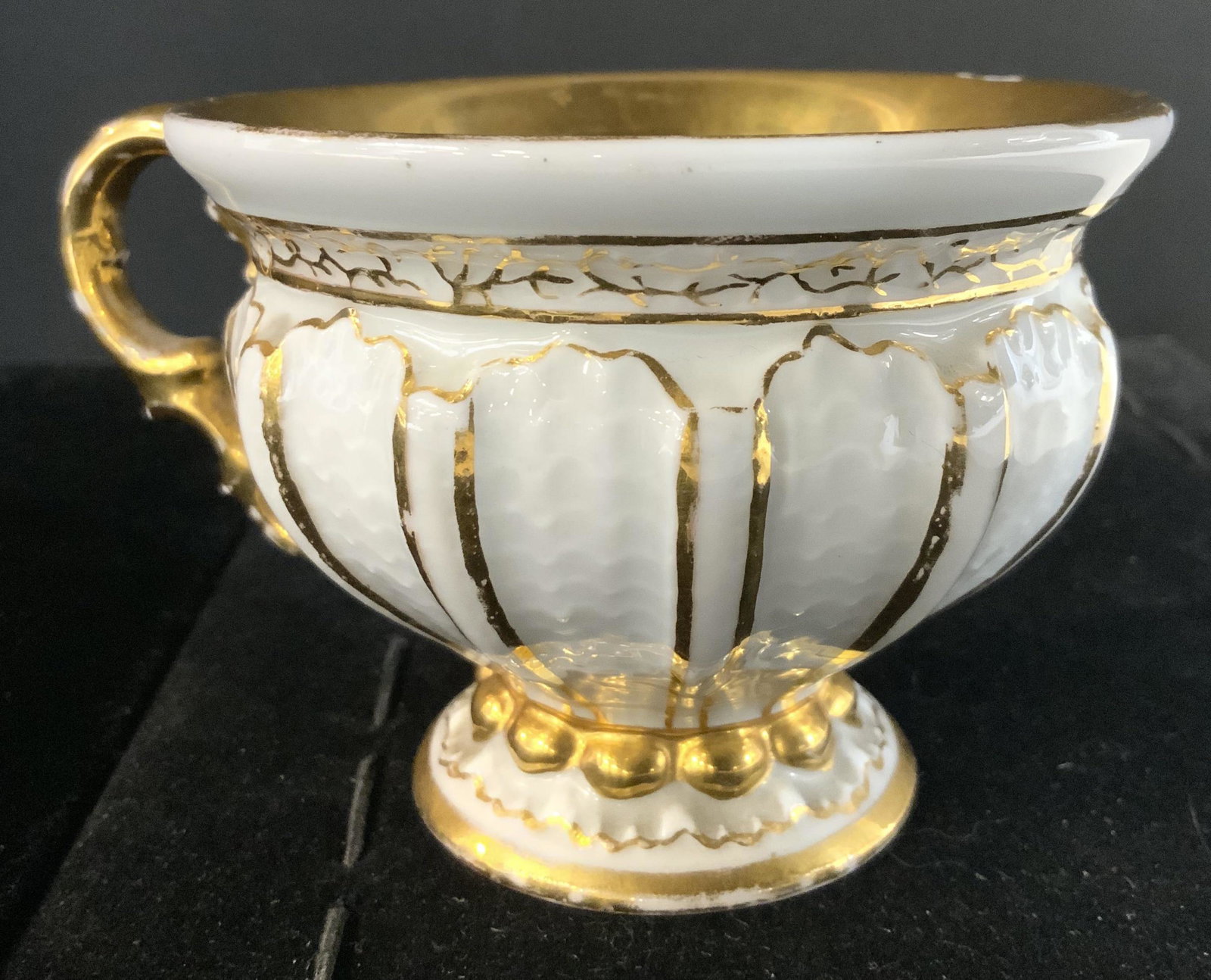 MEISSEN Vintage Porcelain Teacup: Underside of piece has MEISSEN Trademark. Piece is white with gold toned gilt detail. Piece has gold toned handle. Piece measures approx 3 inches tall 4.5 inches deep 3.5 inches wide. Teacup, Meissen 