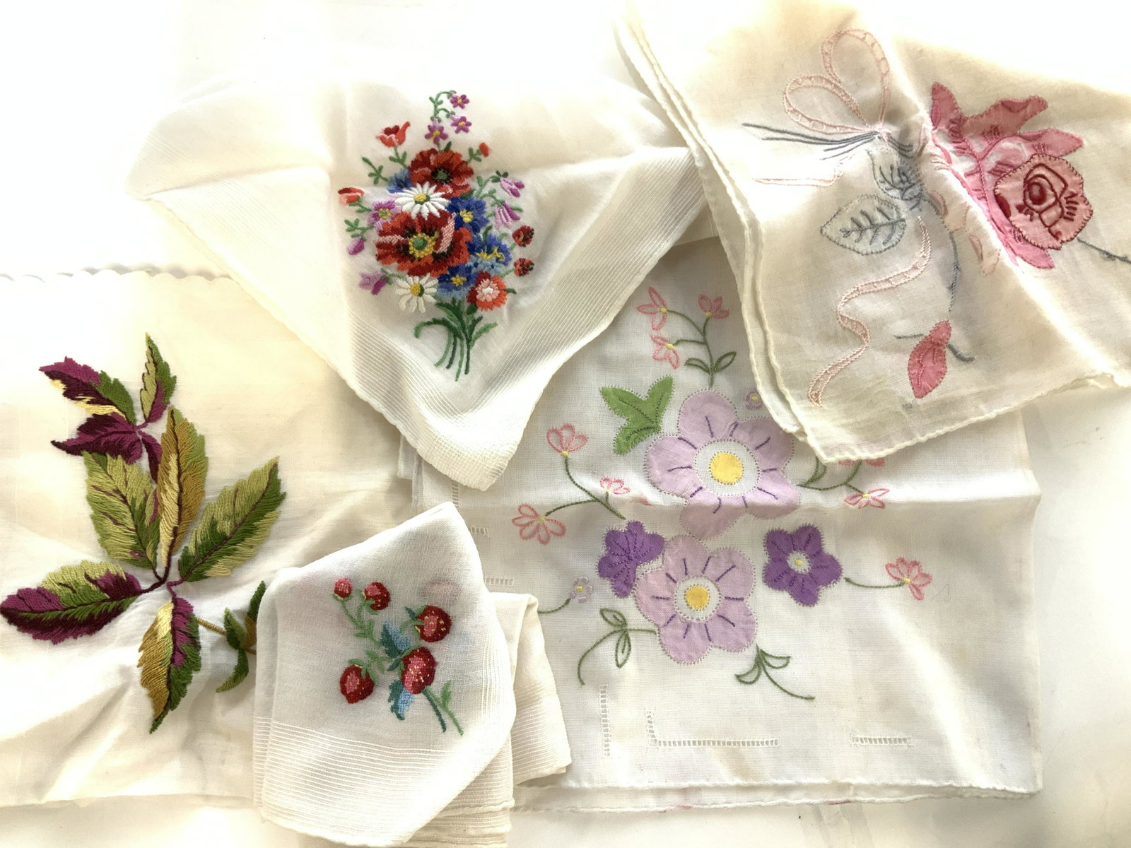 Lot Vintage Cotton Hankies w Embroidery: Sheer white Hand rolled Cotton hand towel/ dinner napkins made in Portugal. Several Hand Embroidered Or petite point cotton Hankies, all flower motif with beautiful bright colors. Ave size 11 x 11 in.