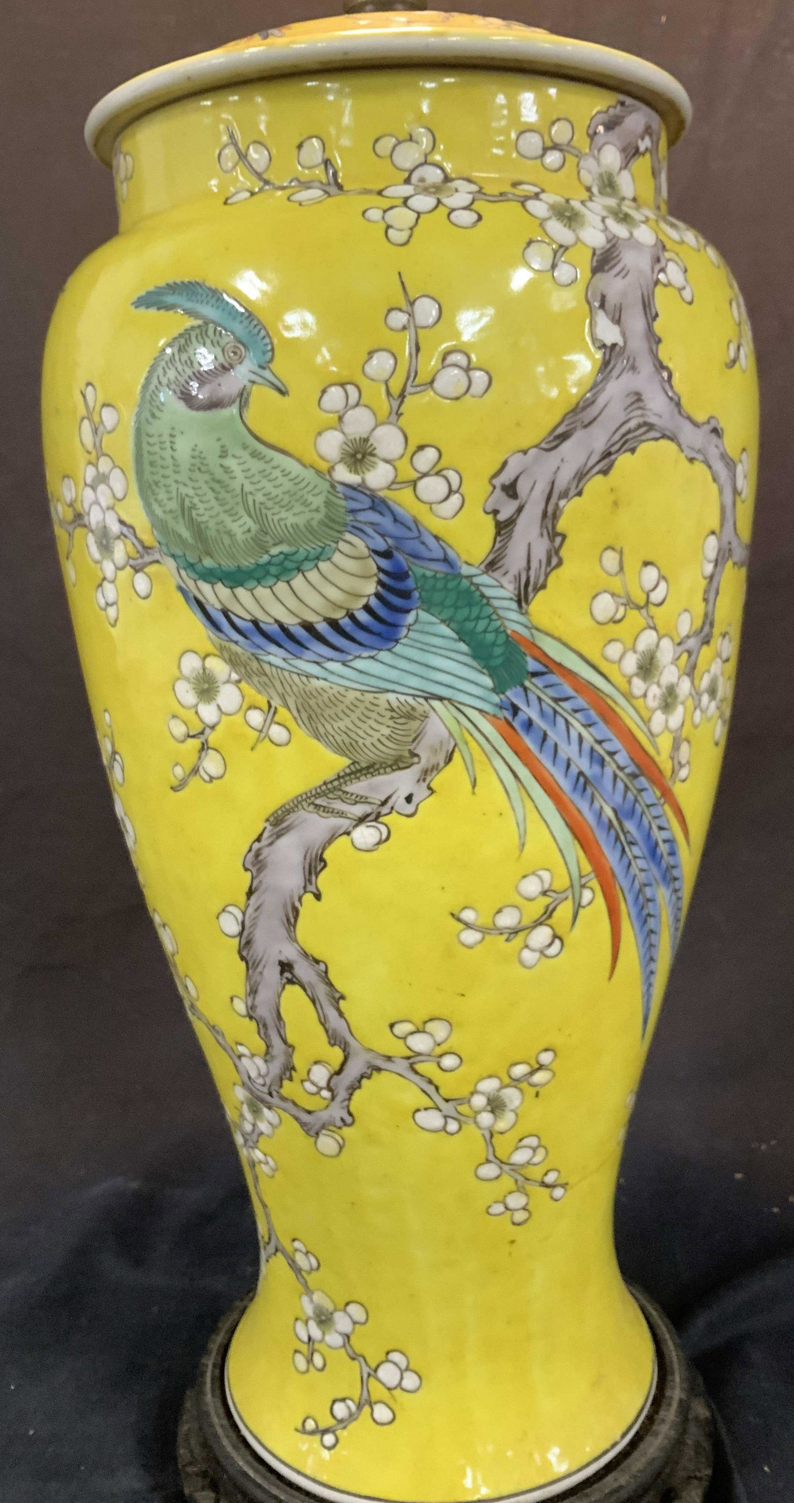 Chinese Porcelain Lamp with Pheasant and Blossom: Bright yellow lamp depicting colorful pheasant in cherry blossom tree, a vintage hand painted and glazed Portable lamp masterpiece. Attached to Chinese carved wood base. Ht with lamp harp 31 in. 8 in.
