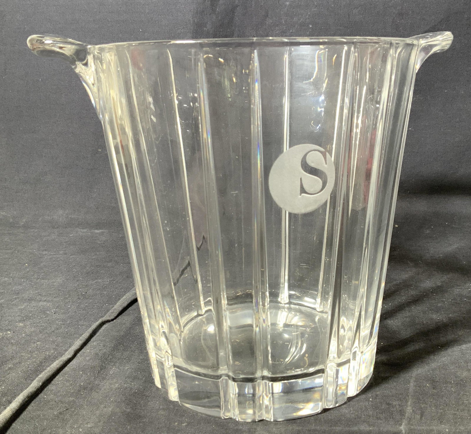 Mid Century Crystal Ice Bucket: Thick walled crystal ice bucket with handles, modernist cut design with linear pattern. Engraved S within frosted circle on front. High crystal pitch. 9 in. W. 7 in. Tall. Weighted piece. Vintage Crys