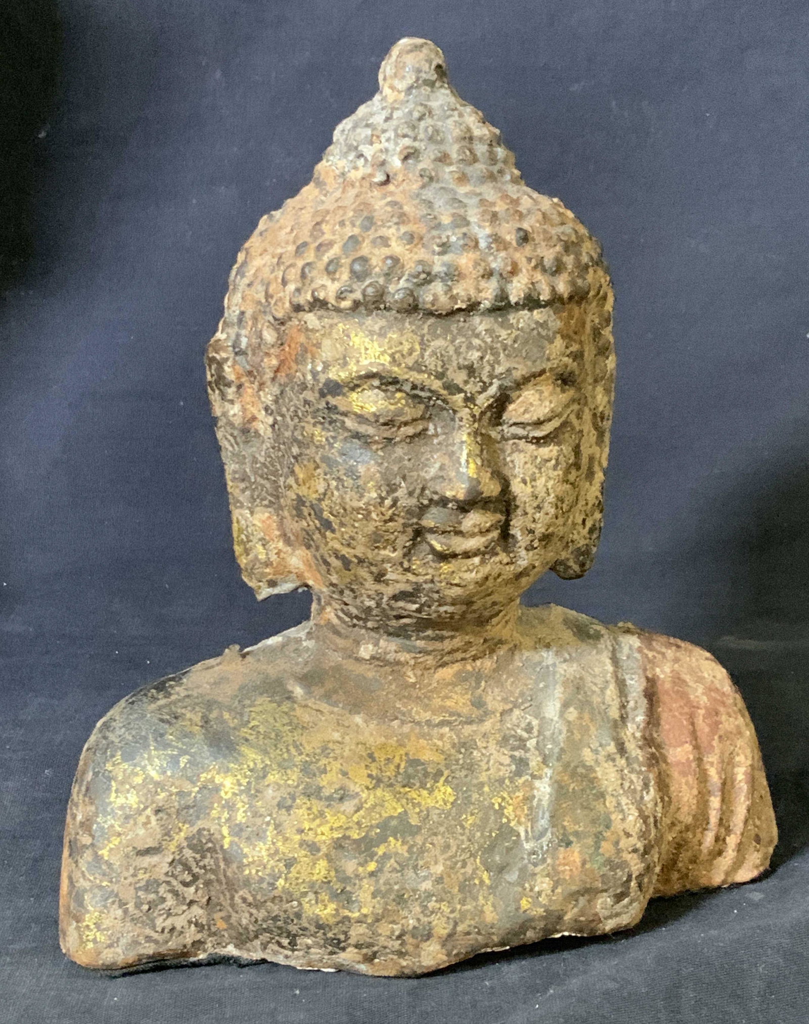 TIBET Buddha Concrete Bust Sculpture: Buddha Bust With hand Painted gold Leaf In areas, Multi chrome hand painted in colors of rust, black, gold and Terra cotta. Underside appears to be a white cement/ composite. Medium weight. Measures 7