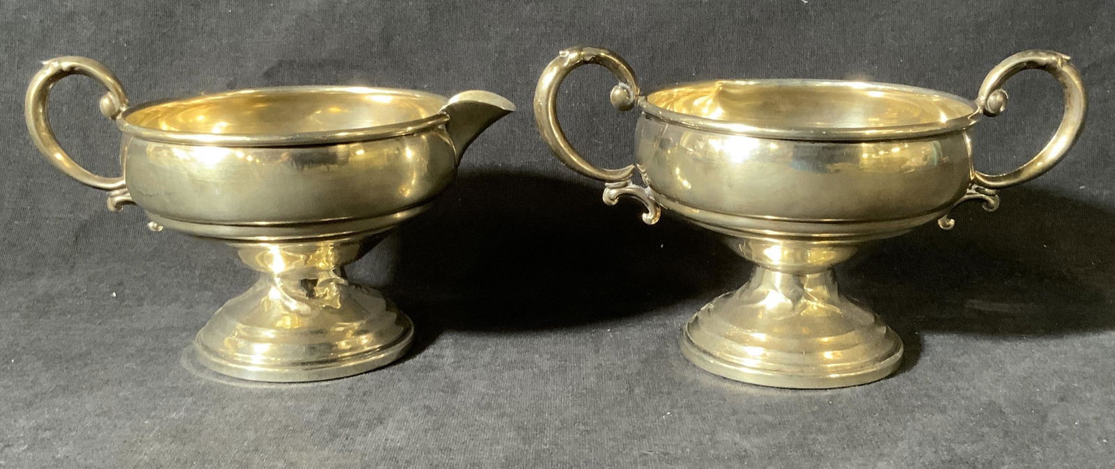 Set 2 REVERE SILVER Sterling Sugar Bowl & Creamer: Set 2 REVERE SILVER Sterling Sugar Bowl & Creamer, inscriptions read ‘Revere Silversmiths Inc Sterling Reinforced With Cement 825’, creamer measures 3 1/8 inches tall x 5 1/8 inches wide, sugar bo