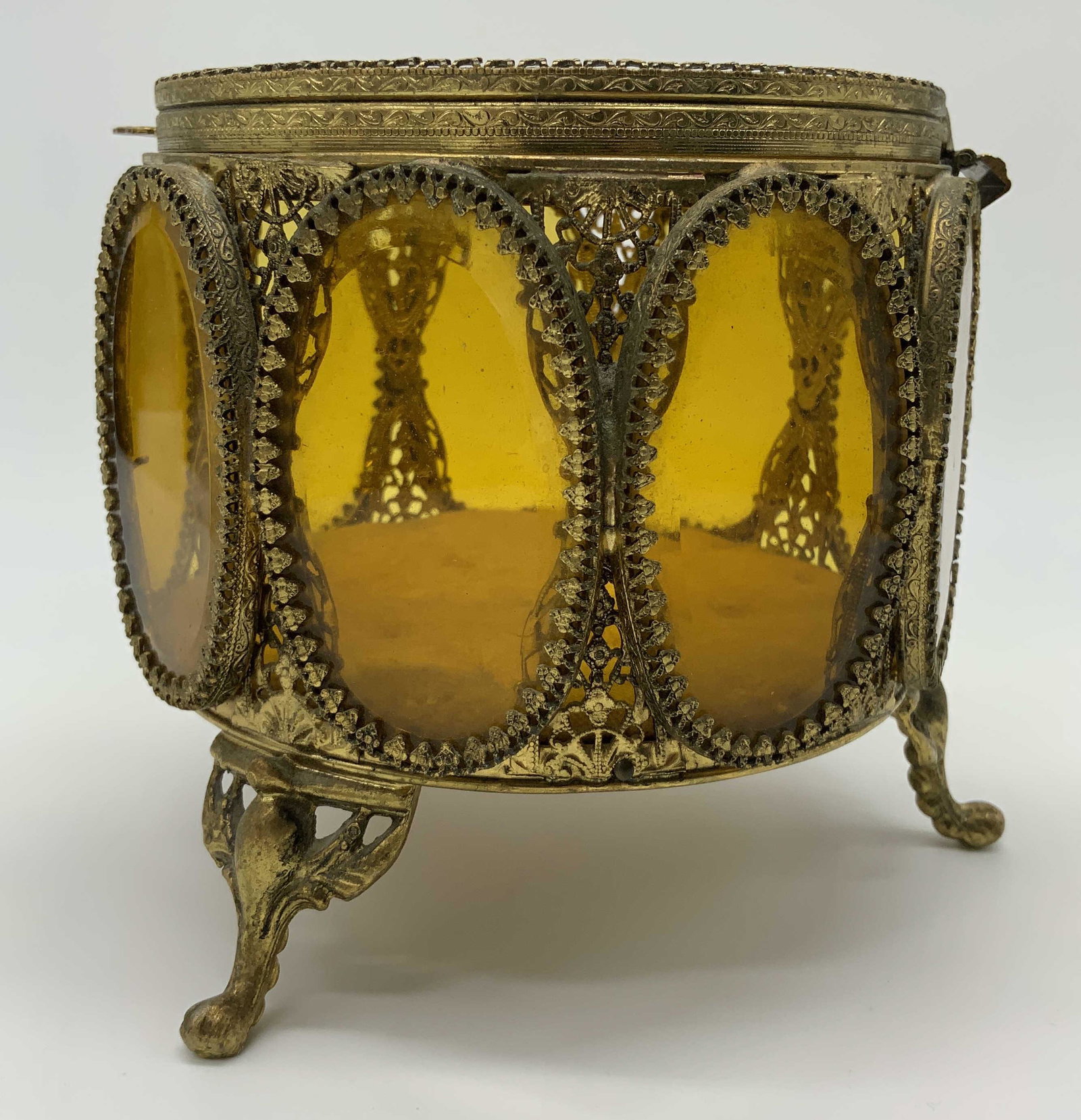 Vintage Filigree and Beveled Glass Dresser Box: Vintage Filigree and Beveled Glass Dresser Box, no apparent inscriptions or marks, footed box with intricate brass detail, measures 5 inches tall x 5 1/8 inches in diameter, surface wear and oxidation