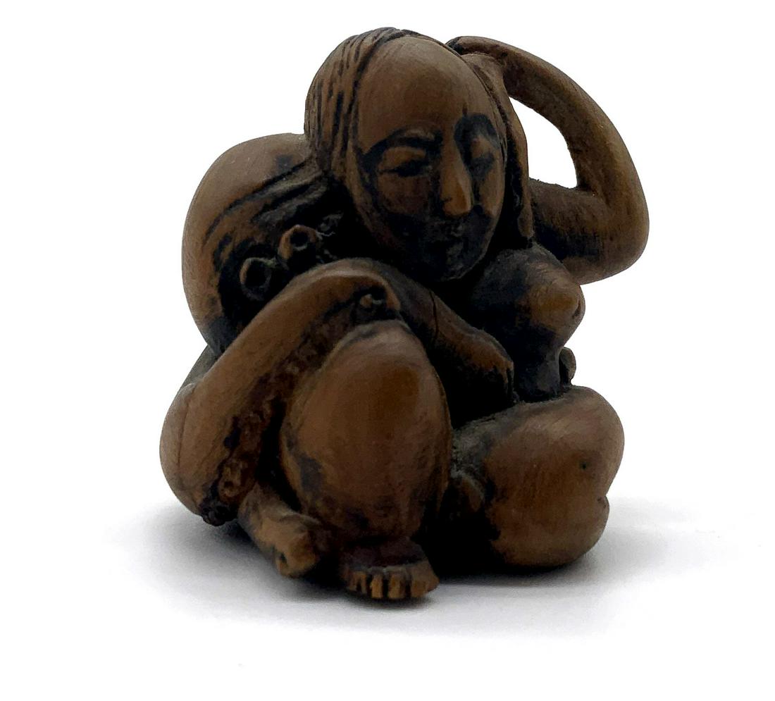 Netsuke Woman & Octopus Carved Wood Figural: Netsuke Woman & Octopus Carved Wood Figural, no apparent inscriptions or signatures, subject a woman sits with an octopus wrapped around her, measures 1 5/8 inches tall x 1 3/8 inches at widest point,