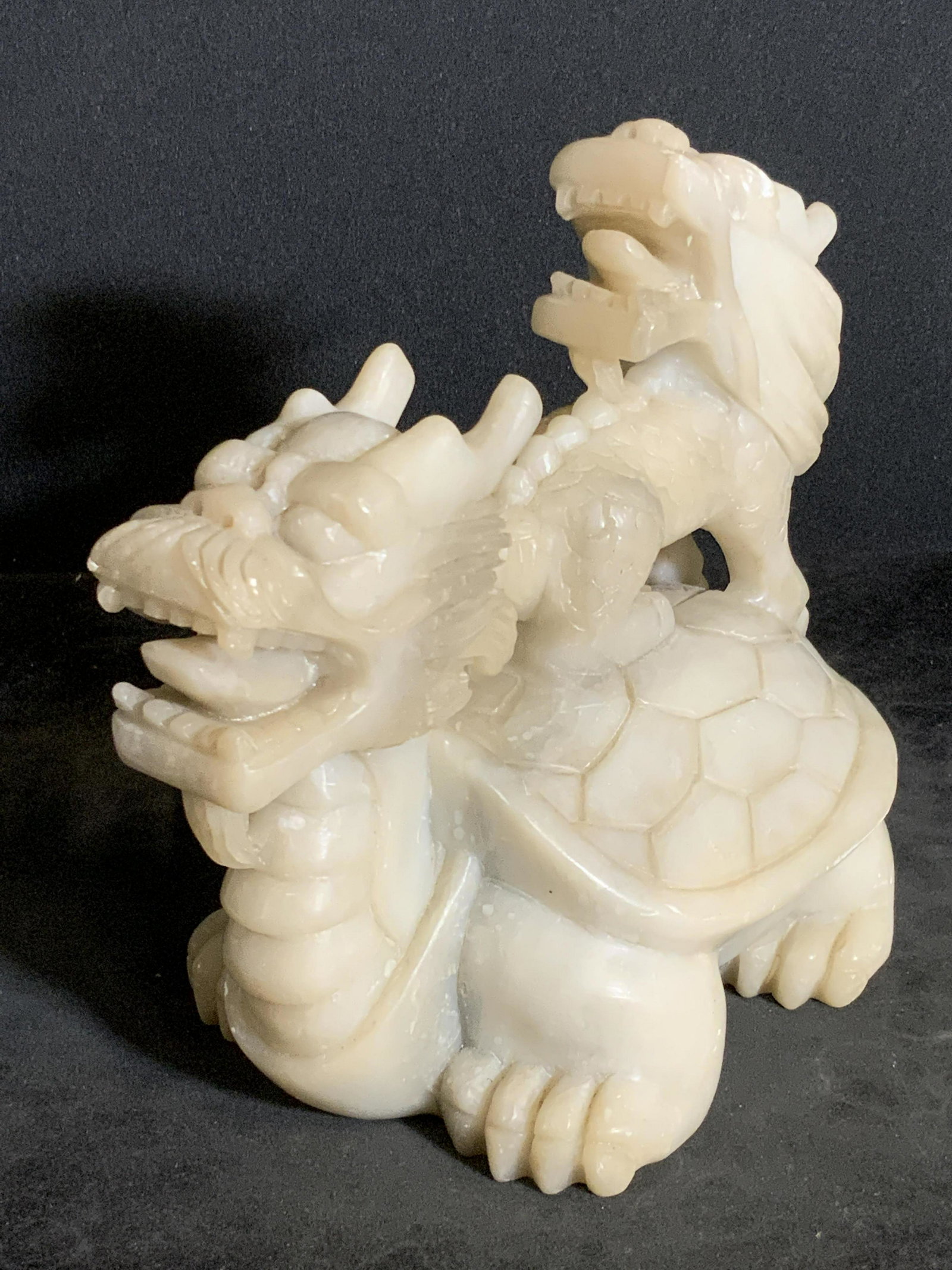 Vntg Natural Stone Asian Dragon Turtle Figural: A vintage carved off white hued natural stone figural, possibly soapstone. Stone depicts a dragon head with a turtle body as the base figural, the figural on the base’s back features a smaller drago