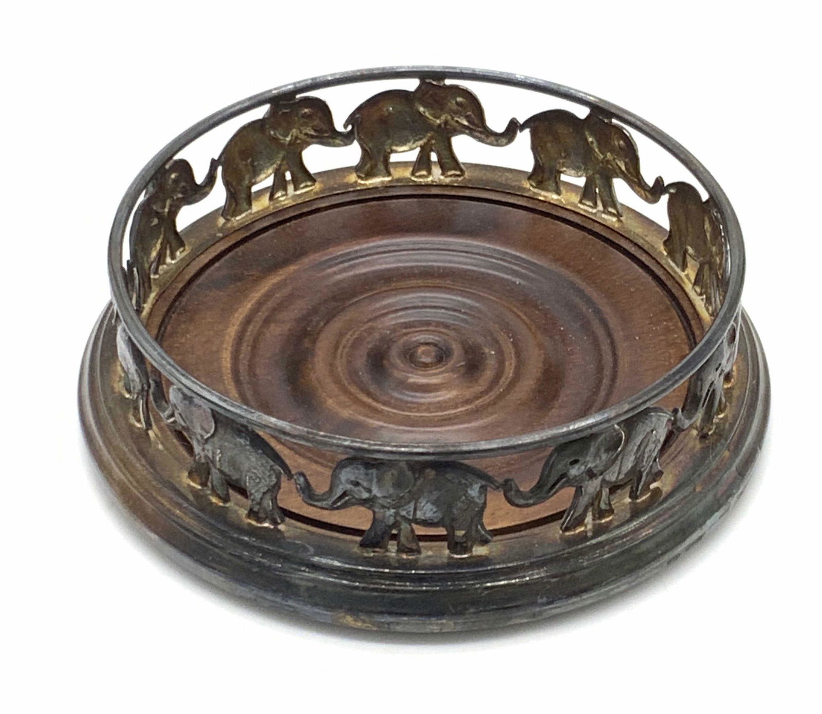 Vntg STERLING SILVER & Wood Elephant Wine Coaster: A vintage sterling silver and wood wine coaster. The piece features a rich chocolate brown carved wooden center rimmed with sterling silver elephant motifs. The sterling accents are marked 925 (sterli