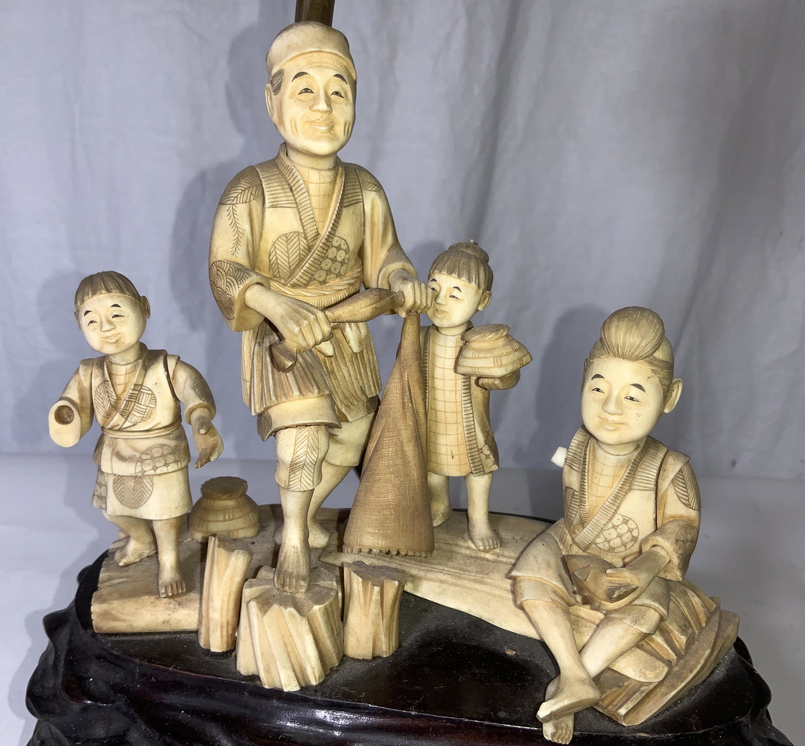 Vintage Asian Carved Bone With Carved Stone: This is a very rare Asian Lamp with carved bone Figurals tiered atop a solid piece of mahogany wood in rock form above a baroque style openwork , etched brass footed stand. Three carved gemstones cent