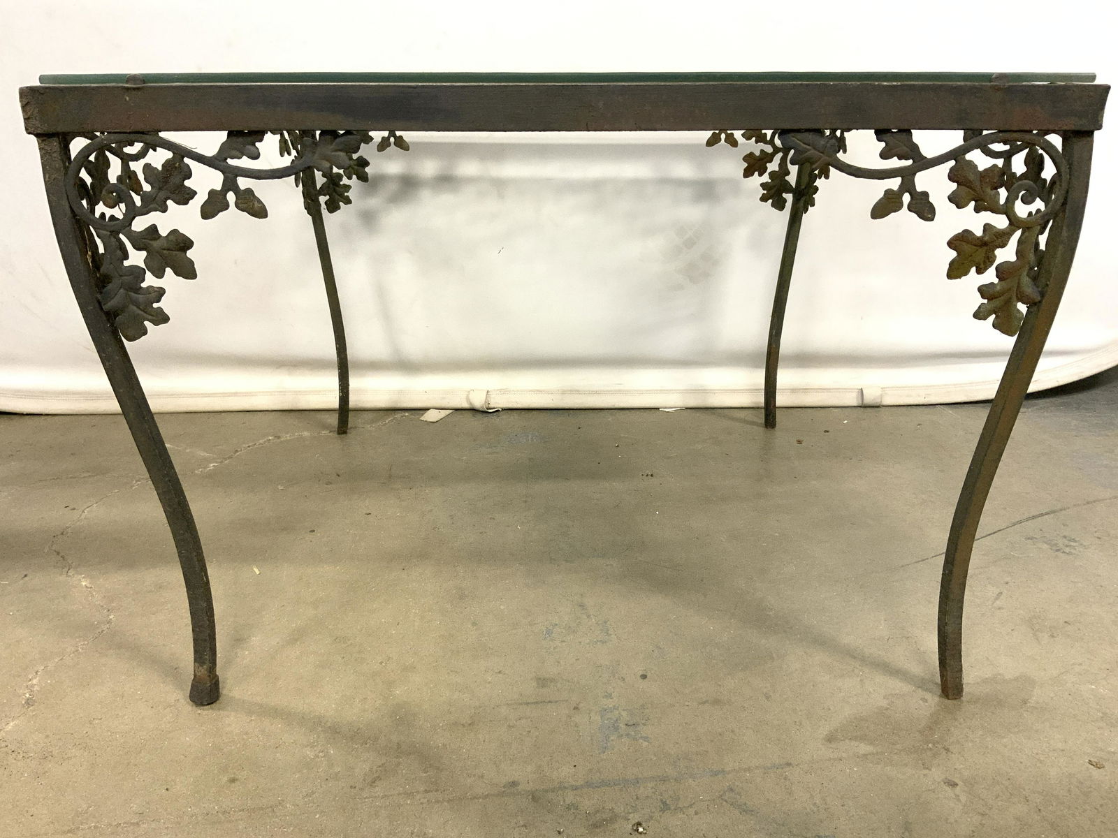 Vtg SALTERINI Outdoor Iron Square Glass Top Table: Table is attributed to SALTERINI. Piece appears to be iron. Table is vintage possibly antique. Underneath table top at corners has vine and leaf structures. Table top is square shaped with glass top.