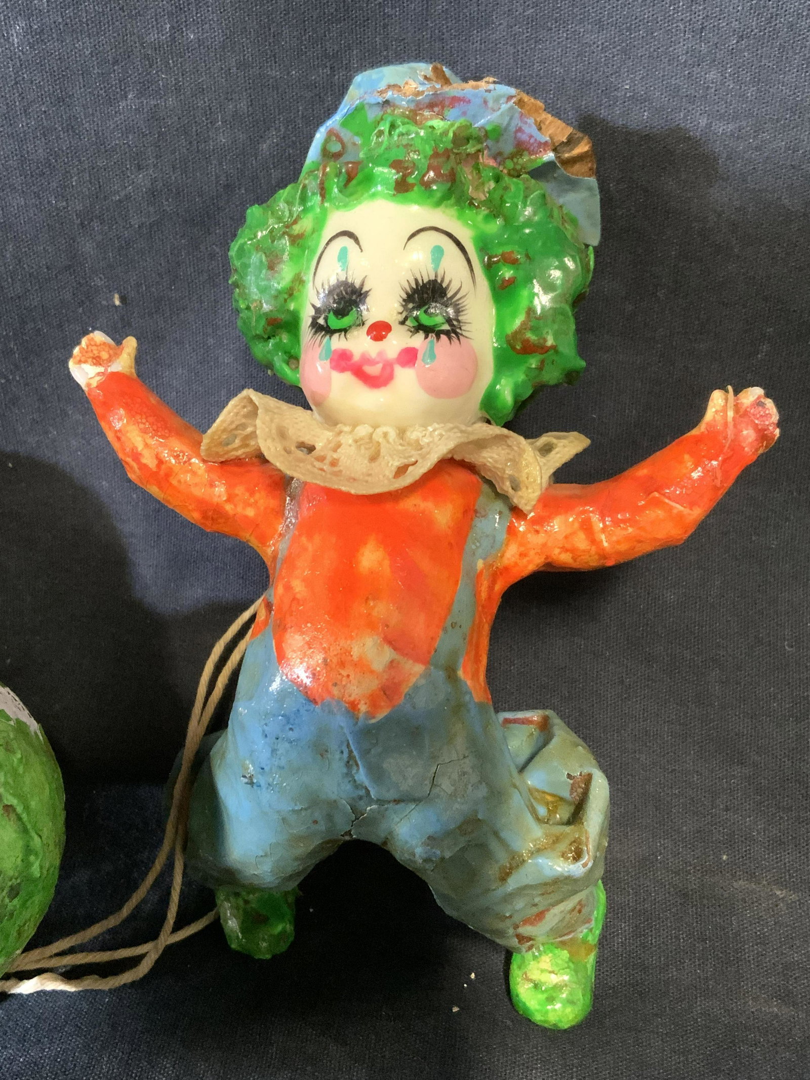 Vintage Paper Mâché Skydiving Clown Toy: Vintage paper mâché clowns. Depicts a child like clown, skydiving, a cluster of balloons acts as it’s parachute. Balloons connected to clown with twine. Hand painted, handmade. Wear is consistent 