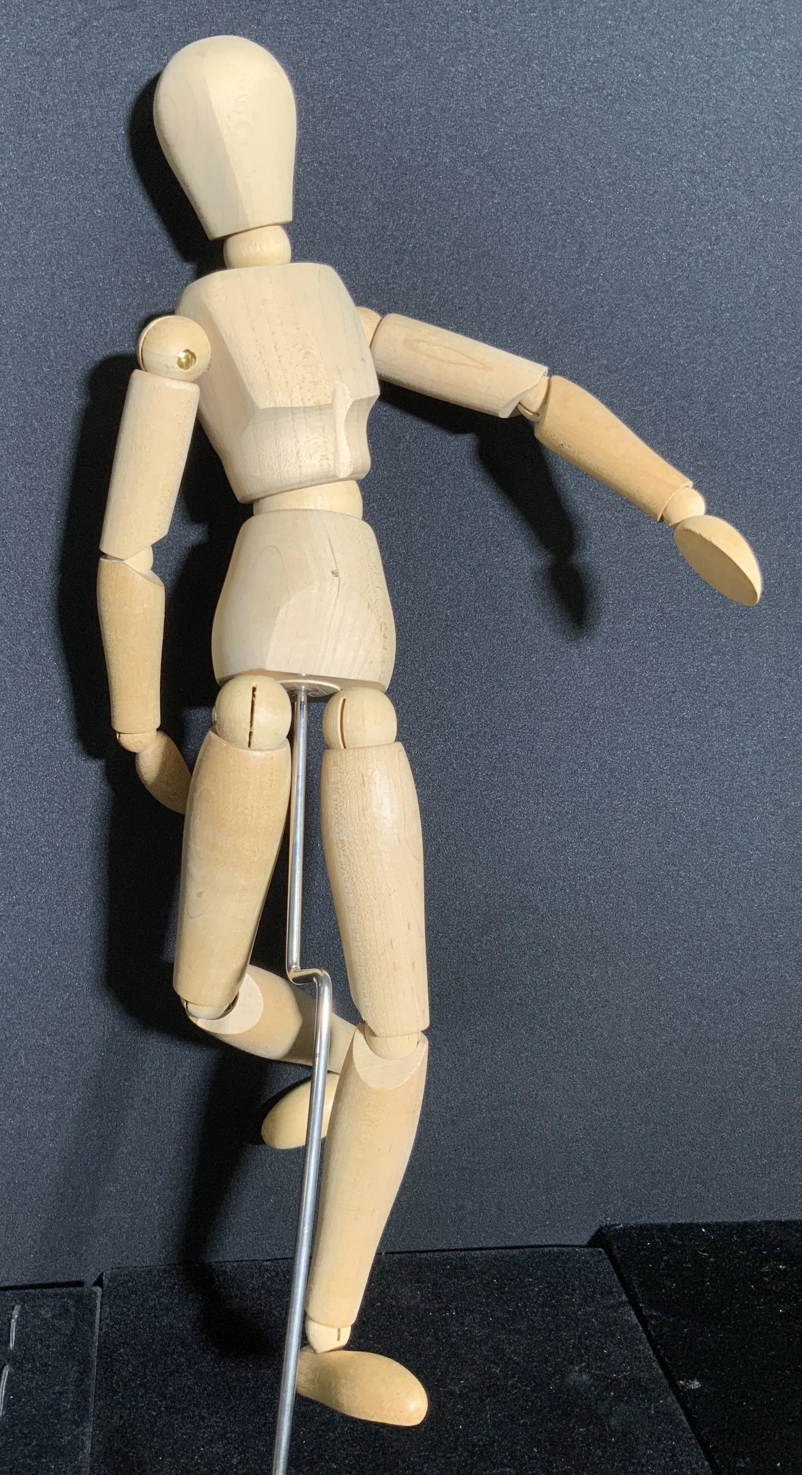 Articulated Wooden Male Manikin, Boxed: A wooden male manikin that comes contained in its original box. The piece features moveable joints and comes with a metal pole piece. The box has evident wear. Manikin measures approx. 16H x 7W in. Ma
