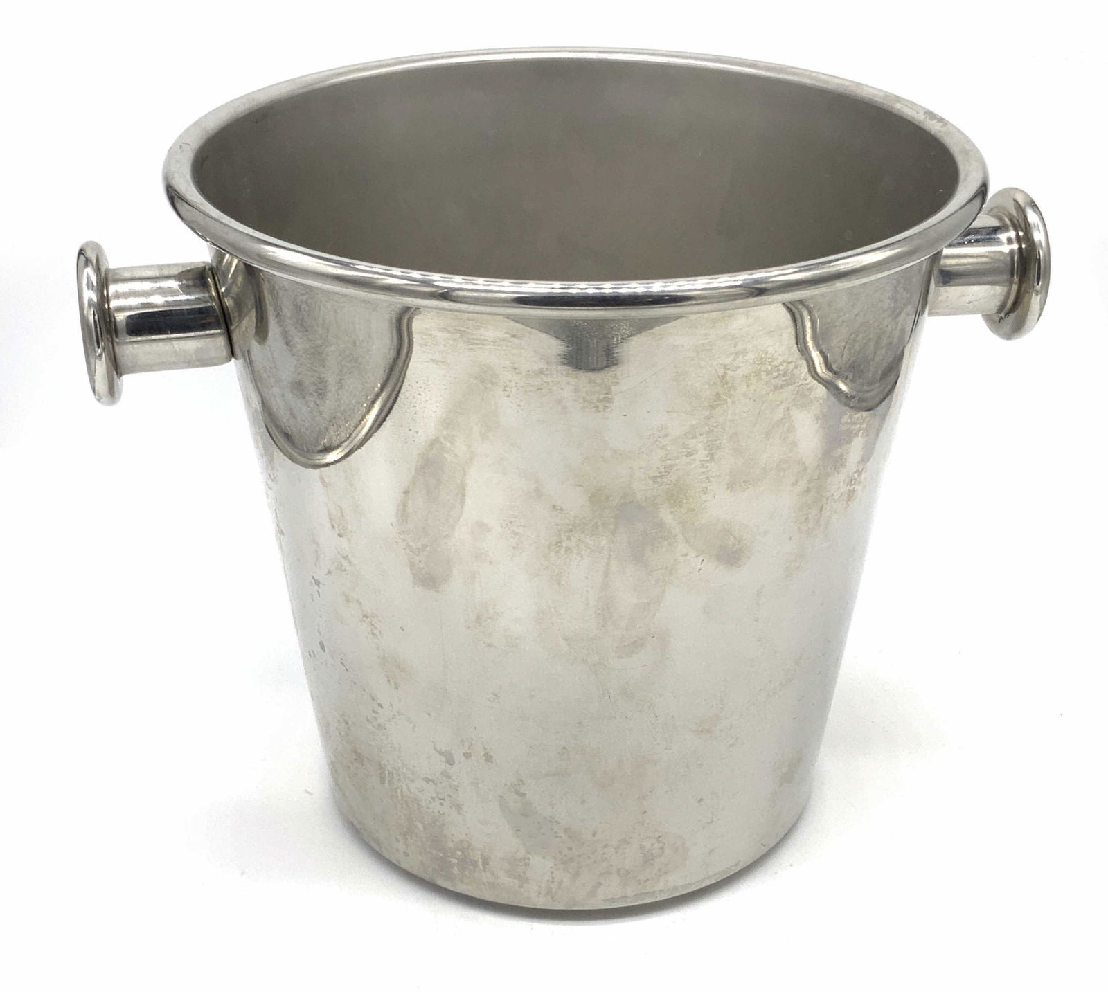 Signed ALESSI Italian Stainless Steel Ice Bucket: A polished stainless steel metal ice bucket / wine cooler with two twin handles. The underside is signed ALESSI, ITALY, INOX 18/10. Approx. 9.5H x 12W in. Piece has some weight. Some surface wear. ALE
