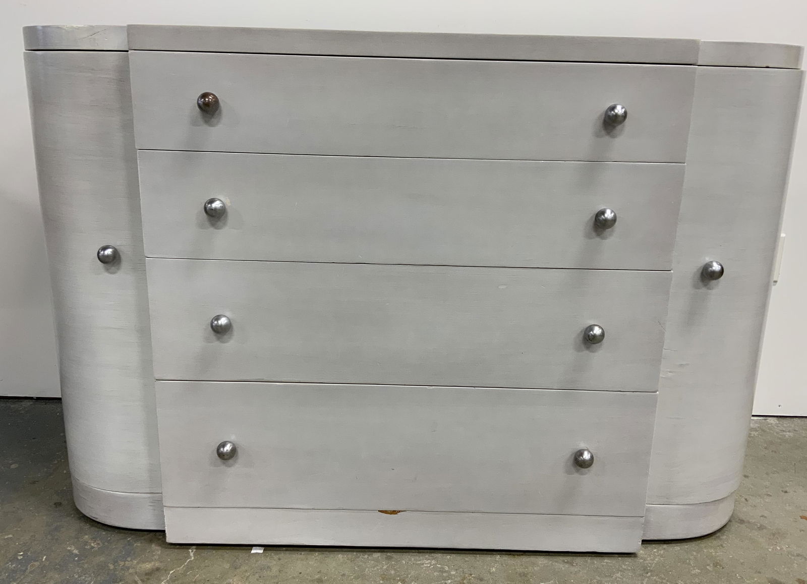 Vintage Art Deco Style Grey Chest: Vintage wooden dresser, Art Deco style. Knobs are metal, spherical in shape. Top drawer is partitioned, split into sections. Appears to be veneered, some chipping present. Original wholesaler label st