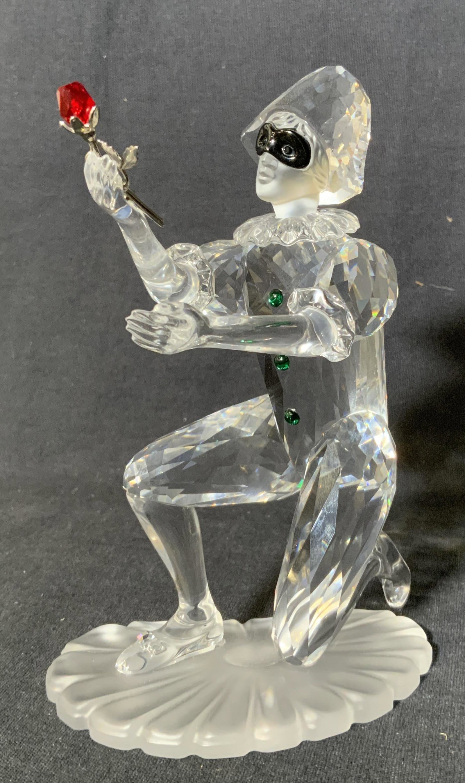 SWAROVSKI Crystal Harlequin Figurine: SWAROVSKI Crystal Harlequin Figurine, inscription to base reads ‘Swarovski 01 A H’, a clown offering a rose, measures 5 3/8 inches tall x 3 3/4 inches wide at base, surface wear to piece, Swarovsk
