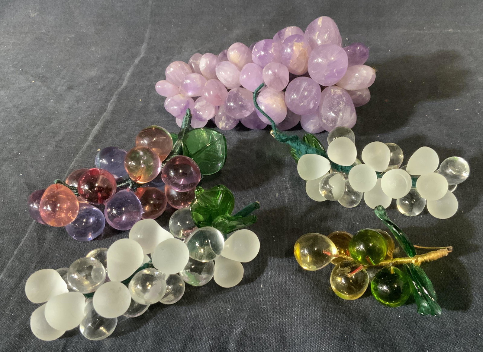 Lot of 5 Art Glass and Stone Grapes: Lot of 5 Art Glass and Stone Grapes, no apparent inscriptions or markings, largest piece measures approximately 6 inches in length x 3 1/2 inches at widest point, smallest piece measures approximately