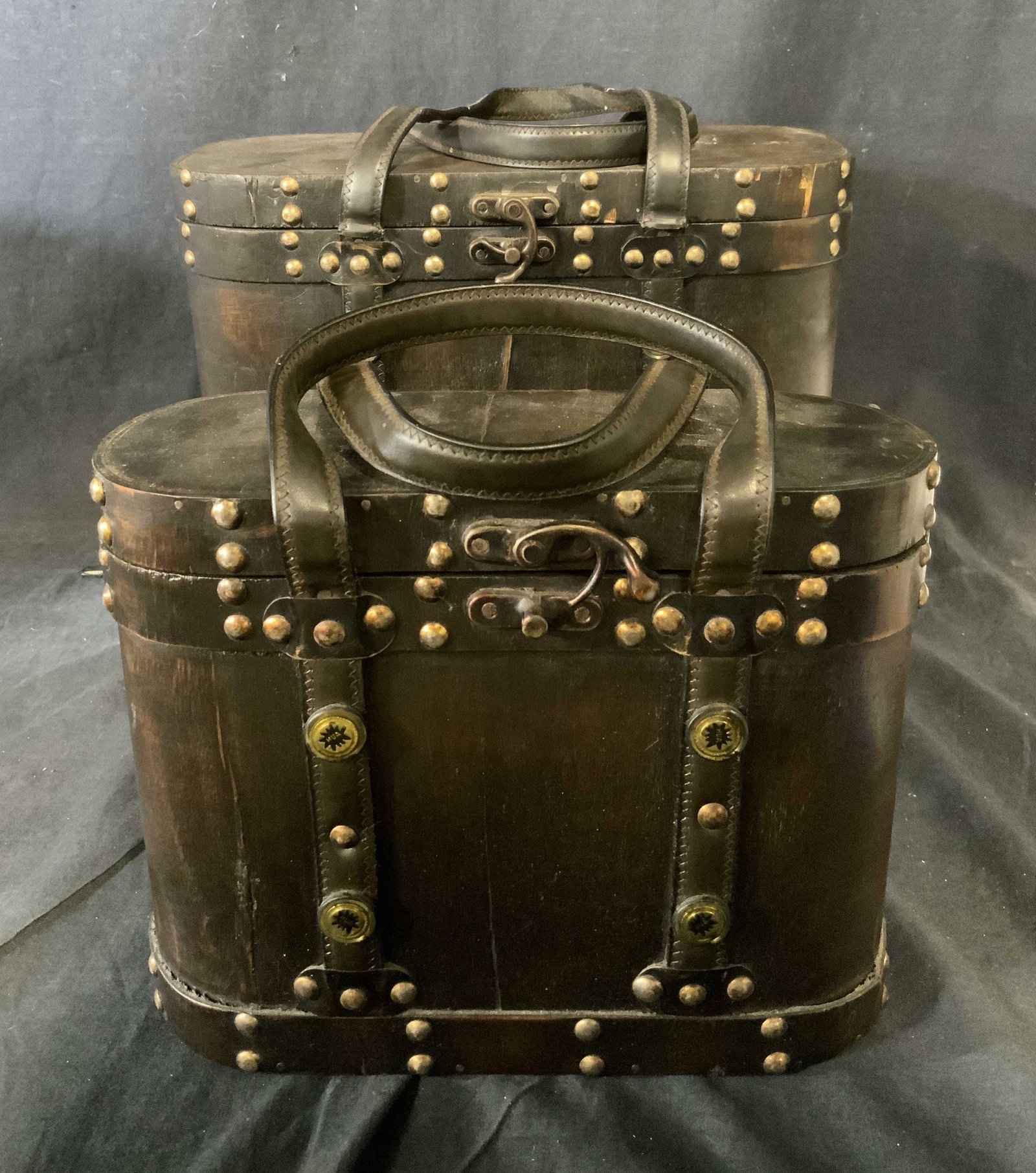 Set of 2 Wooden Nesting Travel Cases: Set of 2 Wooden Nesting Travel Cases, largest item measures 11 inches tall x 13 3/8 inches at widest point, smallest item measures 8 5/8 inches tall x 11 inches at widest point, surface wear to both p