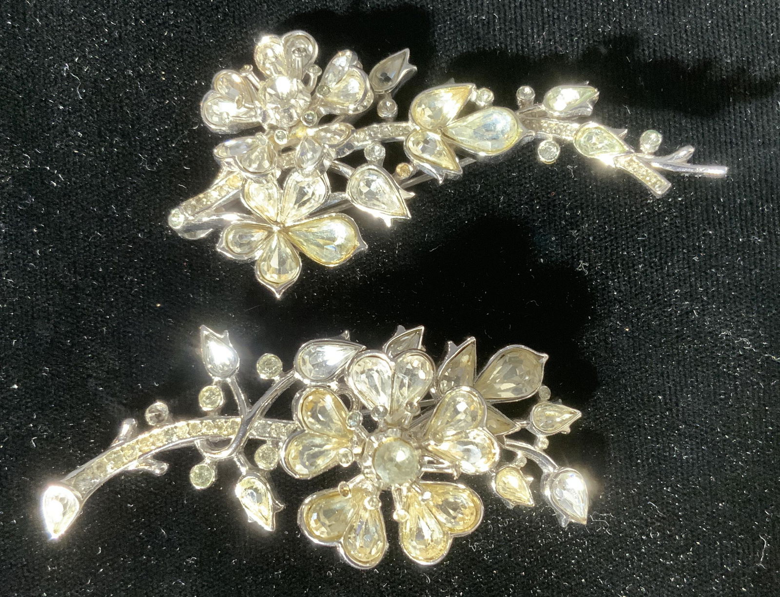 Lot 2 TRIFARI Rhinestone Brooches: Lot 2 TRIFARI Rhinestone Brooches, inscriptions read ‘TRIFARI’, one measures 2 7/8 x 1 1/8 inches, other measures 2 7/8 x 1 1/2 inches, surface wear to pieces, some missing stones, TRIFARI, costum