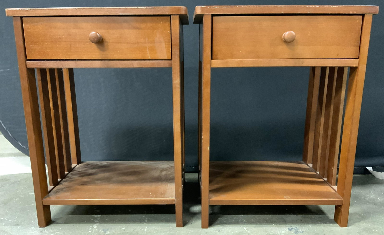 Pair Wooden Nightstands: Lot includes 2 tables. Each are vintage and wooden. Tables each have 1 drawer with wooden knob style handles. Each also have lower tier shelf stretcher. Each measures approx 24 inches tall 18 inches w
