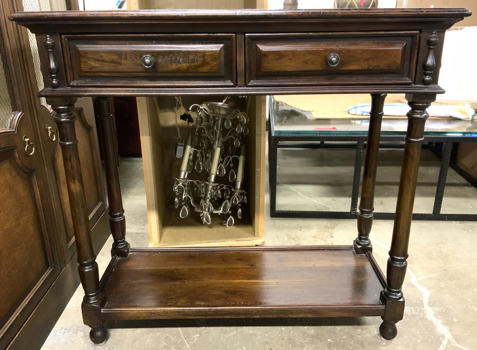 Vintage Wooden Hallway Table: Hallway table is vintage & wooden. Piece has carved detailed structures. Table has 2 drawers each with hand dovetailing with metal knob style handles. Piece measures approx 36 inches tall 39 inches lo