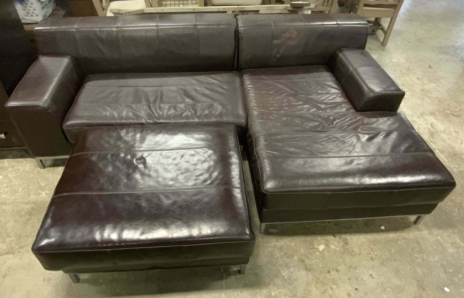 Leather Sectional Sofa: Undersides have tags which reads IKEA. Each piece appears to possibly be leather. Upholstery of each piece is brown toned. Each piece has metal legs. Some wear & small tears present. Piece measures ap