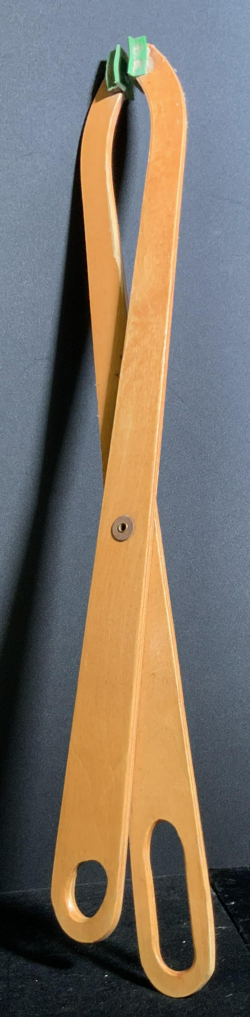 Vintage Wooden Extension Grabber Gadget, Folk Art: A vintage wooden extension grabber gadget / scissor. This folk art piece is crafted from light hued wood. Glossy finish. Tipped off with green rubber style accents. Piece opens and closes. Approx. 27H
