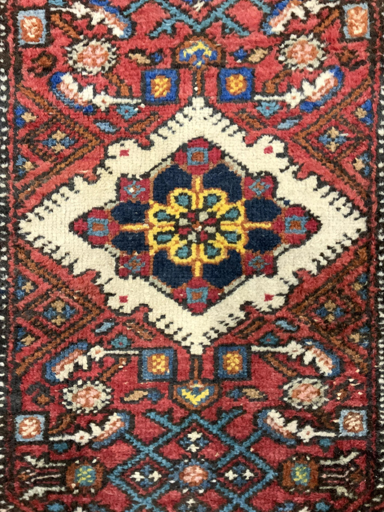Vintage Handmade Wool Area Rug: Rug is handmade and wool. Piece is vintage. Rug contains intricate multi toned floral and geometric detail. Piece measures approx 35 inches long 28 inches wide. Rug, carpet, vintage rug, handmade rug,