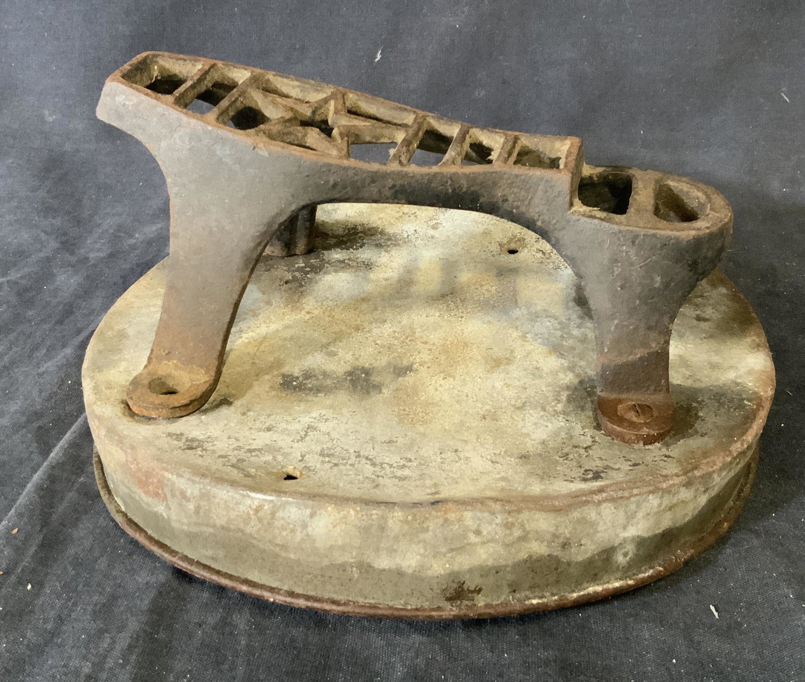 Cast Iron Shoe Shining Shoe Rest: Cast Iron Shoe Shining Shoe Rest, Star shape at center of foot, attached to metal container lid, measures 4 inches tall at highest point x 8 1/2 inches at widest point, surface wear and rusting to pie
