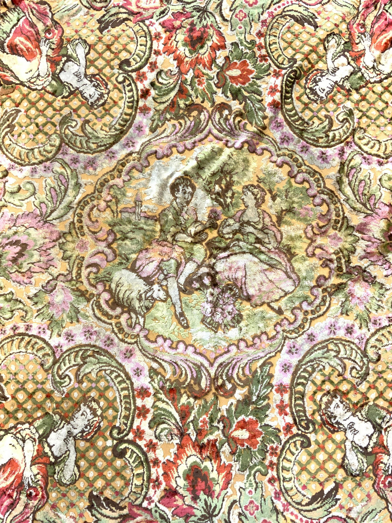 Vintage Crushed Velvet Area Rug: Rug is vintage. Piece appears to Possibly be crushed velvet. Rug has intricate multi toned floral, vine, leaf & figural detail. Piece also has c scroll detail. Piece measures approx 83 inches long 69 