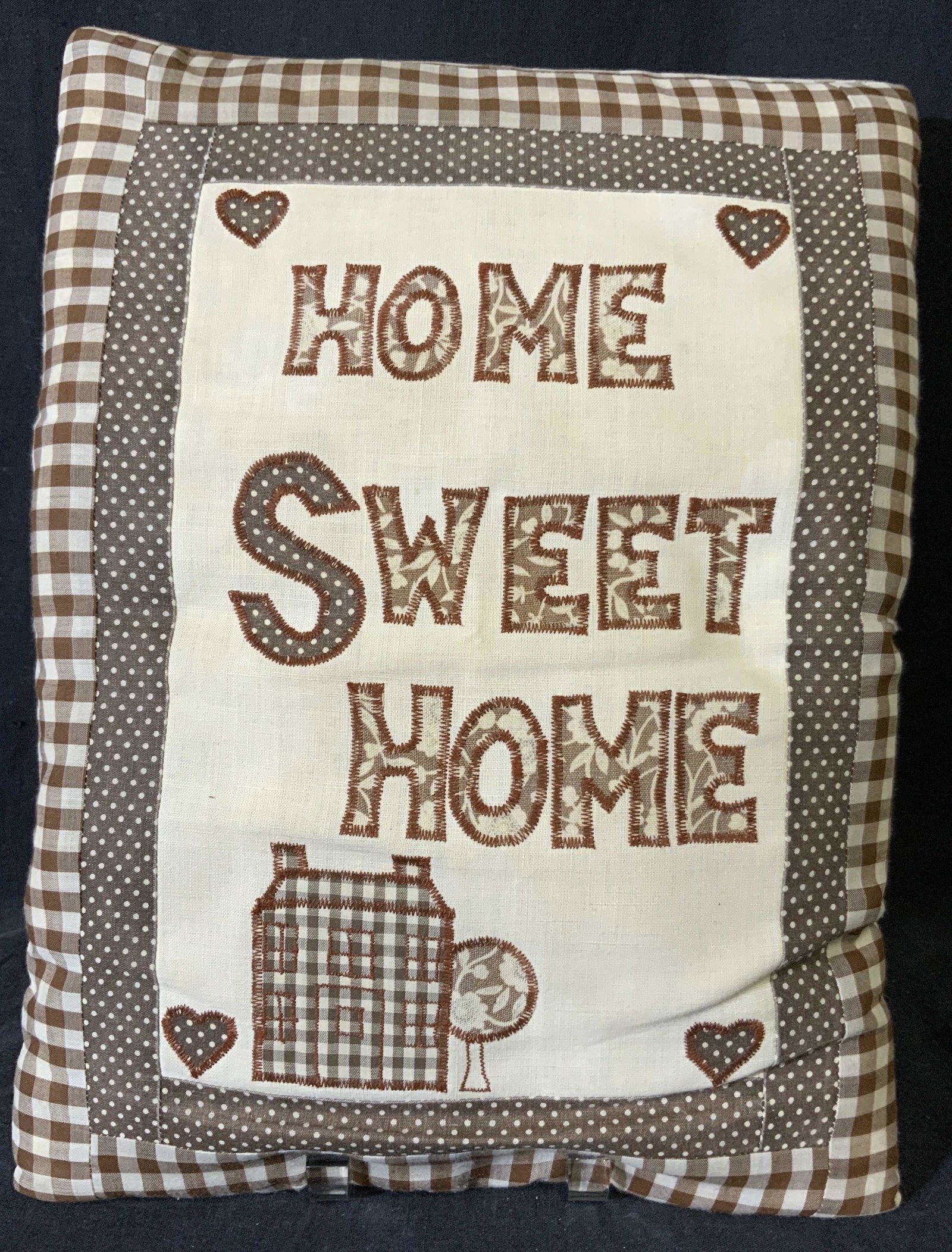 Home Sweet Home Pillow: Home sweet home pillow, possibly vintage, appears to be hand made. Reads as home sweet home. Depicts a house, tree, and several heart shapes. Wear is consistent with age. Measures approx 15 inches lon