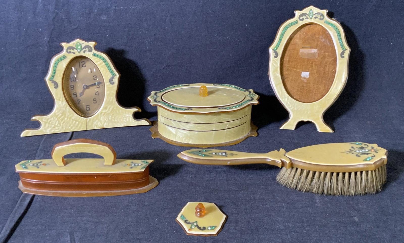 Set 5 Vintage Celluloid Dresser Accessories: Set 5 Vintage Celluloid Dresser Accessories, inscriptions to clock reads ‘The Lux Clock Mfg Co Waterbury Conn’, brush measures 8 7/8 inches long, clock measures 4 5/8 inches tall x 6 5/8 inches wi