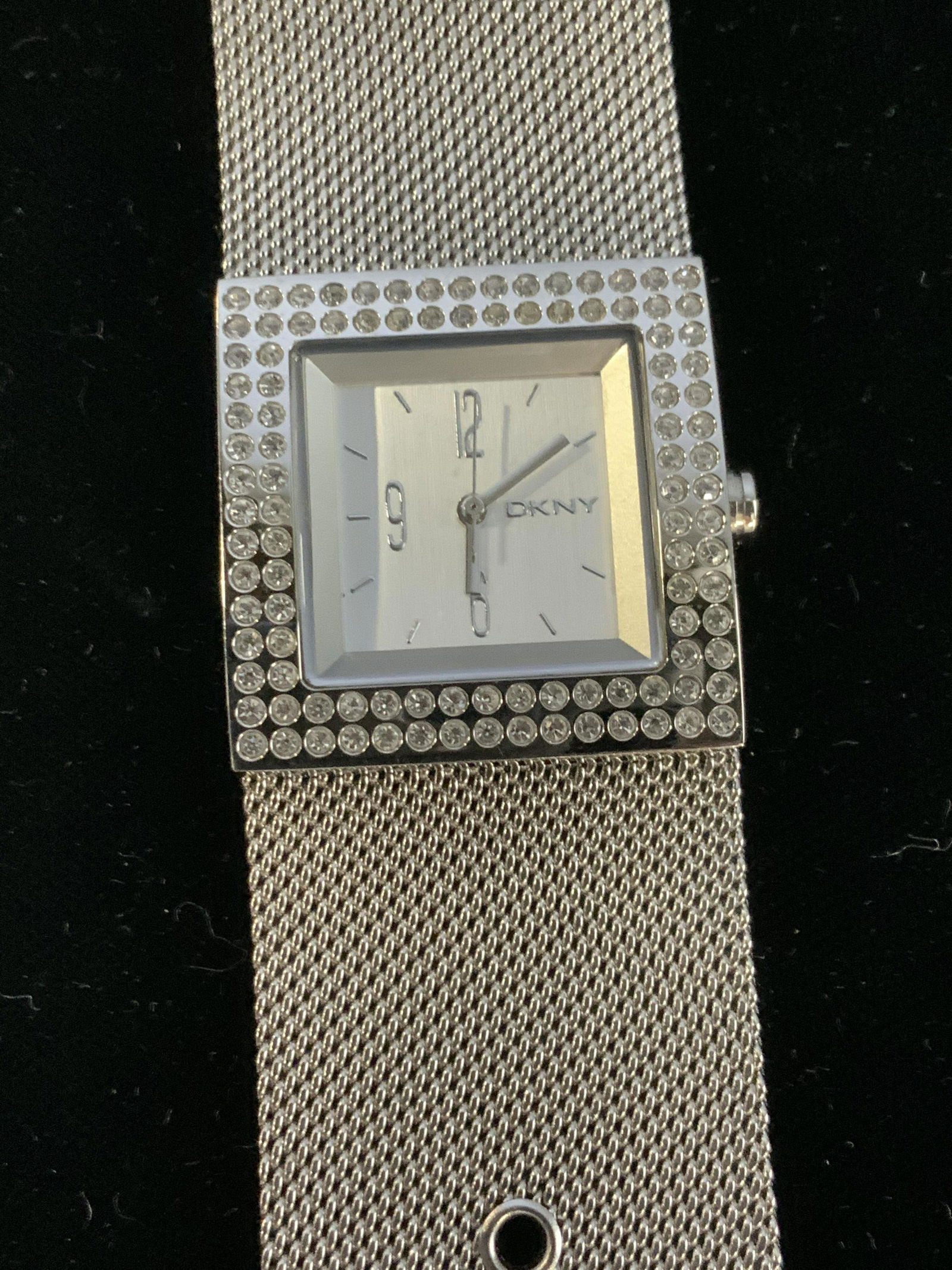 DKNY Mesh Stainless Steel + Crystal 3 ATM Watch: Wide band Metal mesh Band Watch, watch face encased by clear crystals, Signed DKNY, water Resistant, 3 ATM, backside Reads DKNY NY 3404 3 ATM 30 Meters, Stainless Steel.8.5 in. Long with buckle. DKNY
