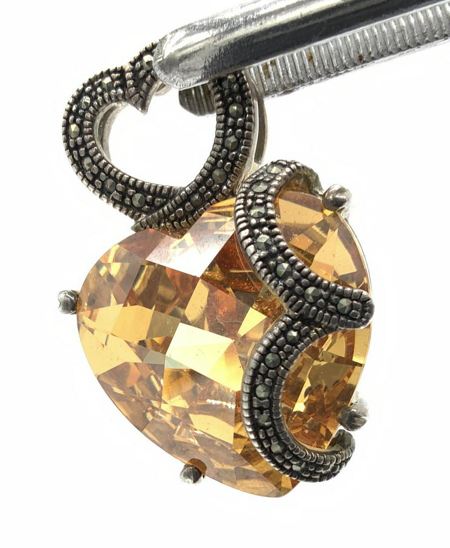 Imperial Topaz Faceted Crystal In Sterling Silver: Sterling Silver and Marcasite 4 print setting pendant, heart bail , Hallmarked 925. Sterling Is holding in a heart shape multi faceted Austrian Crystal , the color of imperial topaz. measures 1.5 in. 