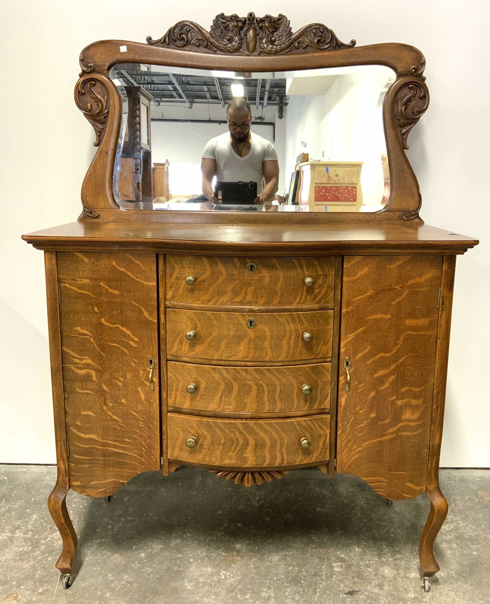 Trademarked Antique Carved Wooden Vanity: Backside of piece has trademarked tag. Vanity is antique and wooden. Piece appears to possibly be hand crafted. Top of mirror has ornate carved wooden C, S scroll & dragon detail. Lower half of piece 