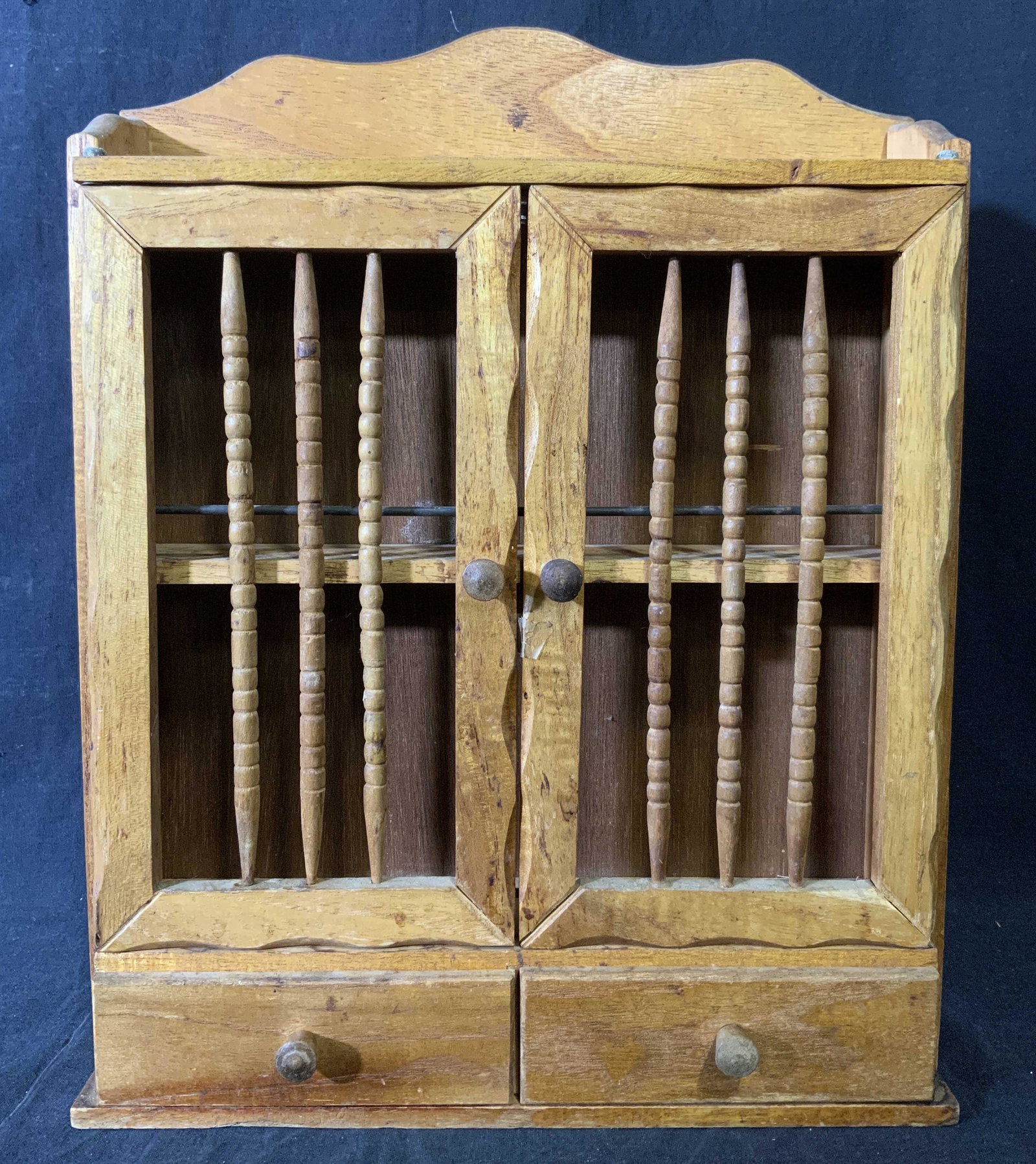 Vintage Wooden Spice Cabinet: Vintage, possibly antique, wooden spice cabinet. House two drawers, drawer pulls need to be reattached. Wear is consistent with age and use. Spindles in doors need to be reattached. Measures approx 14