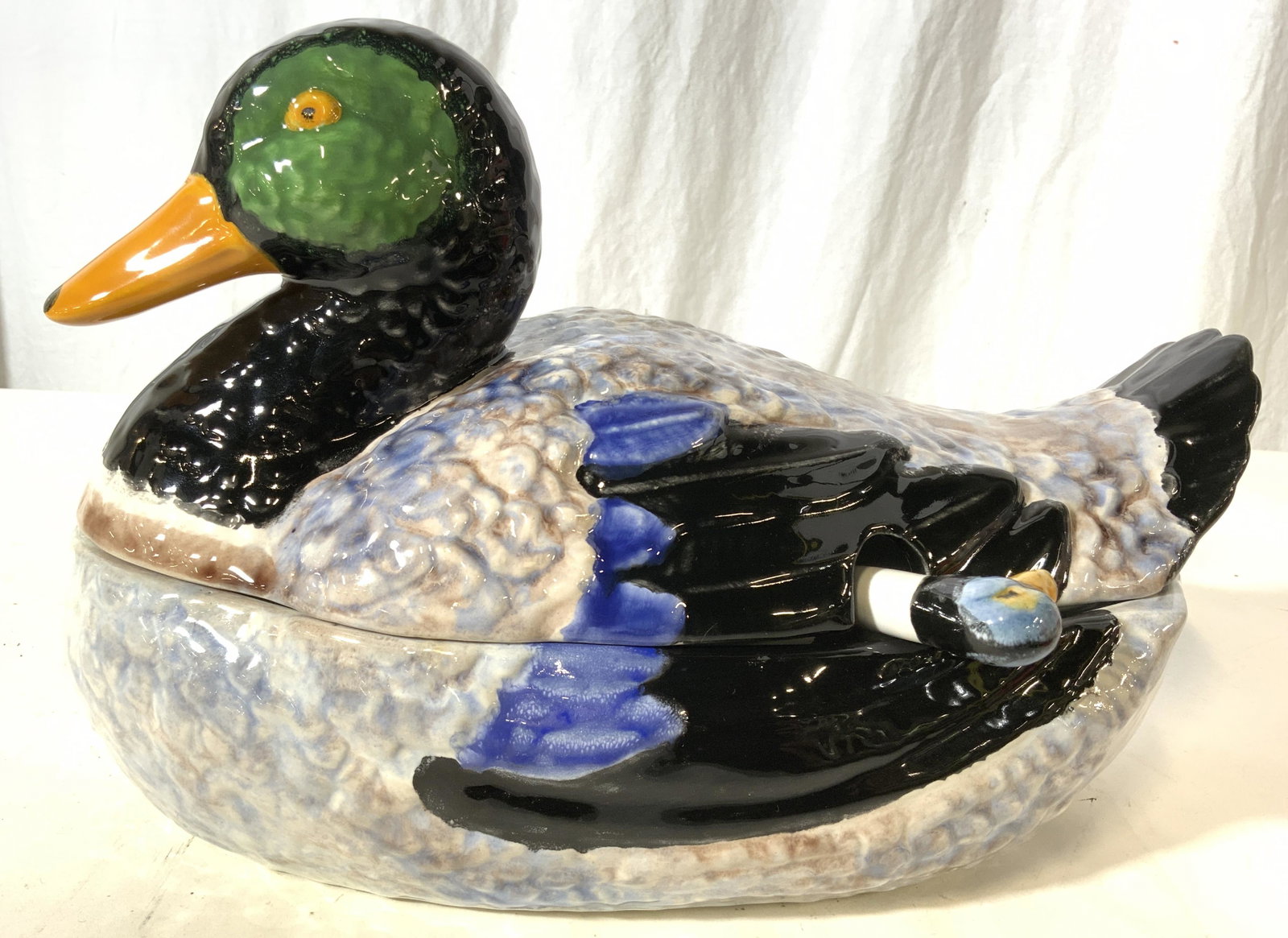 BORDALLO PINHEIRO PORCELAIN Duck Tureen & Ladle: Underside of piece is marked BORDALLO PINHEIRO PORTUGAL. Jar is porcelain, possibly hand painted. Piece is detailed to resemble a duck. Piece measures approx 12.5 inches deep 8 inches tall & wide. Duc
