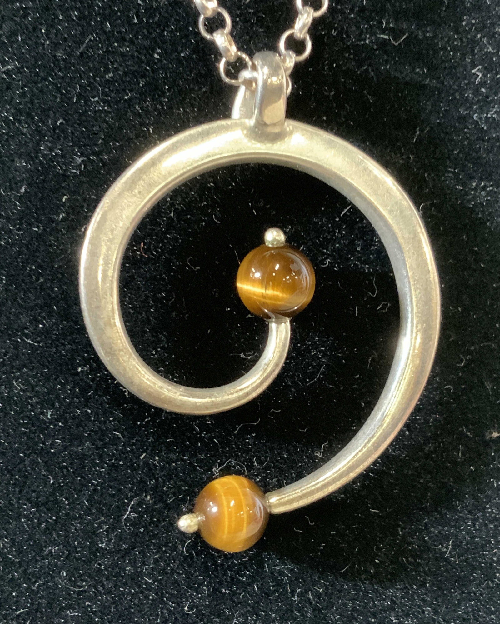 Sterling Silver Chain Pendant w Tigers Eye, Italy: Signed .925 Italian Silver Chain, located near clasp. .48 ozt total weight. Abstract pendant with 2 tigers eyes beads, one on each end. Chain measures 16+ in. Pendant measures 1.25 in. W Sterling silv