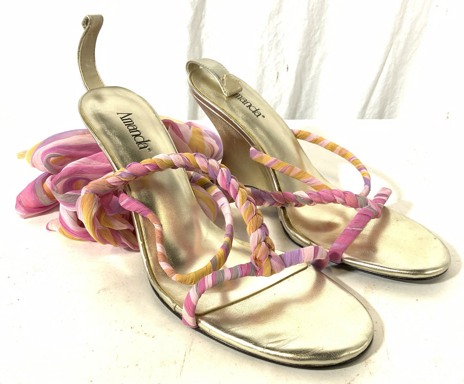 Pair AMANDA Heels W Ribbon Wraps: Heel soles read AMANDA. Shoes are gold toned with black toned undersides. Each shoe has multi toned stripe detail. Shoes measure approx 9.5 inches long 4 inches tall 3.25 inches wide. Shoes, heels, pa