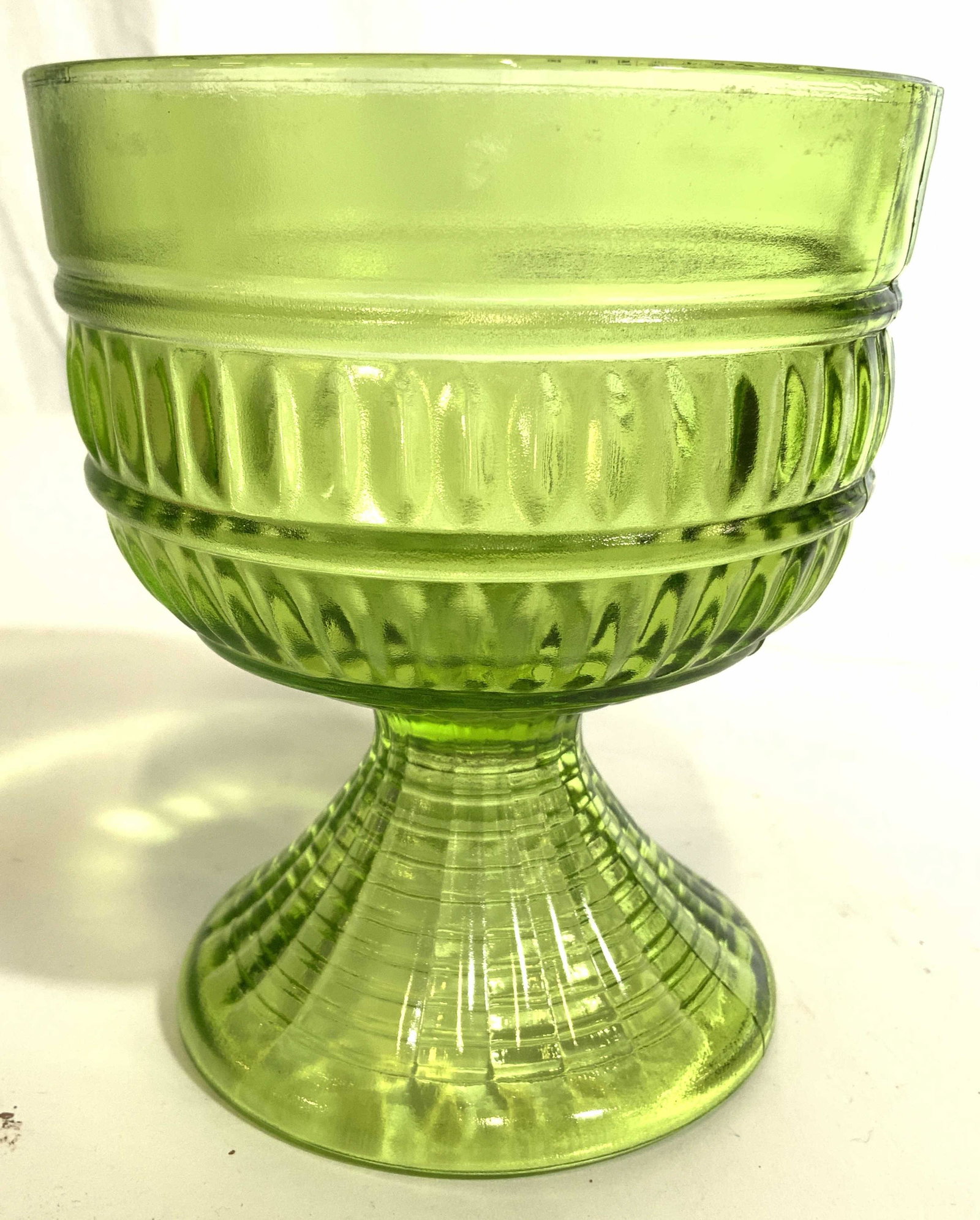 Depression Glass Art Glass Goblet: Goblet is green toned and glass. Piece has geometric relief detail. Piece measures approx 5.5 inches tall 4.5 inches wide. Depression glass, Art glass, goblet glass goblets, Art glass goblet, vessel, 