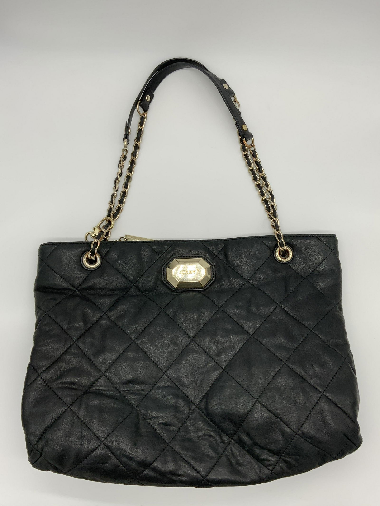 DKNY Quilted Leather Handbag: DKNY Quilted Leather Handbag with magnetic closure, inscriptions read ‘DKNY’, measures 11 x 14 3/8 inches, drop measures 9 inches, surface wear to bag, tarnishing to hardware, DKNY, Donna Karan, l