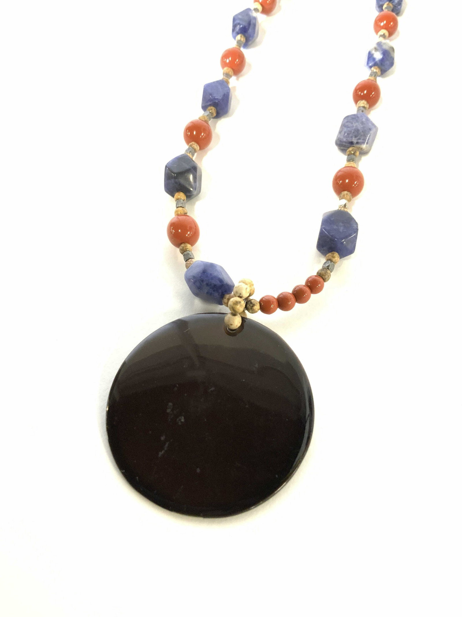 Lapis & Carnelian Necklace w Pendant: Adjustable Necklace, 18 in. Signed designers, Coro or Corols. Alternating Lapiz and carnelian beads with round flat disc pendant, measuring 1.25 in. Ladies necklace, natural stone, lapis lazuli, carne