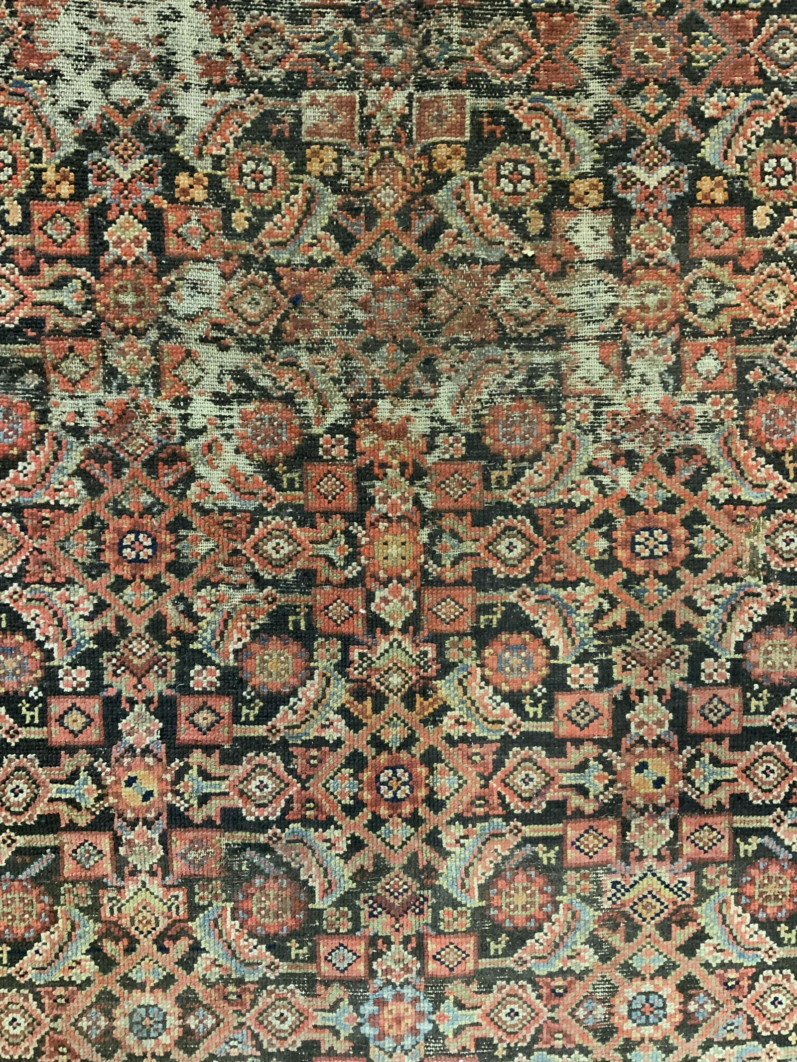 Antique Handmade Persian Wool Area Rug: Rug is wool and handmade. Piece is vintage possibly antique. Piece has intricate multi toned floral, leaf & geometric detail. Piece measures approx 75 inches long 48 inches wide. Rug, carpet, area rug