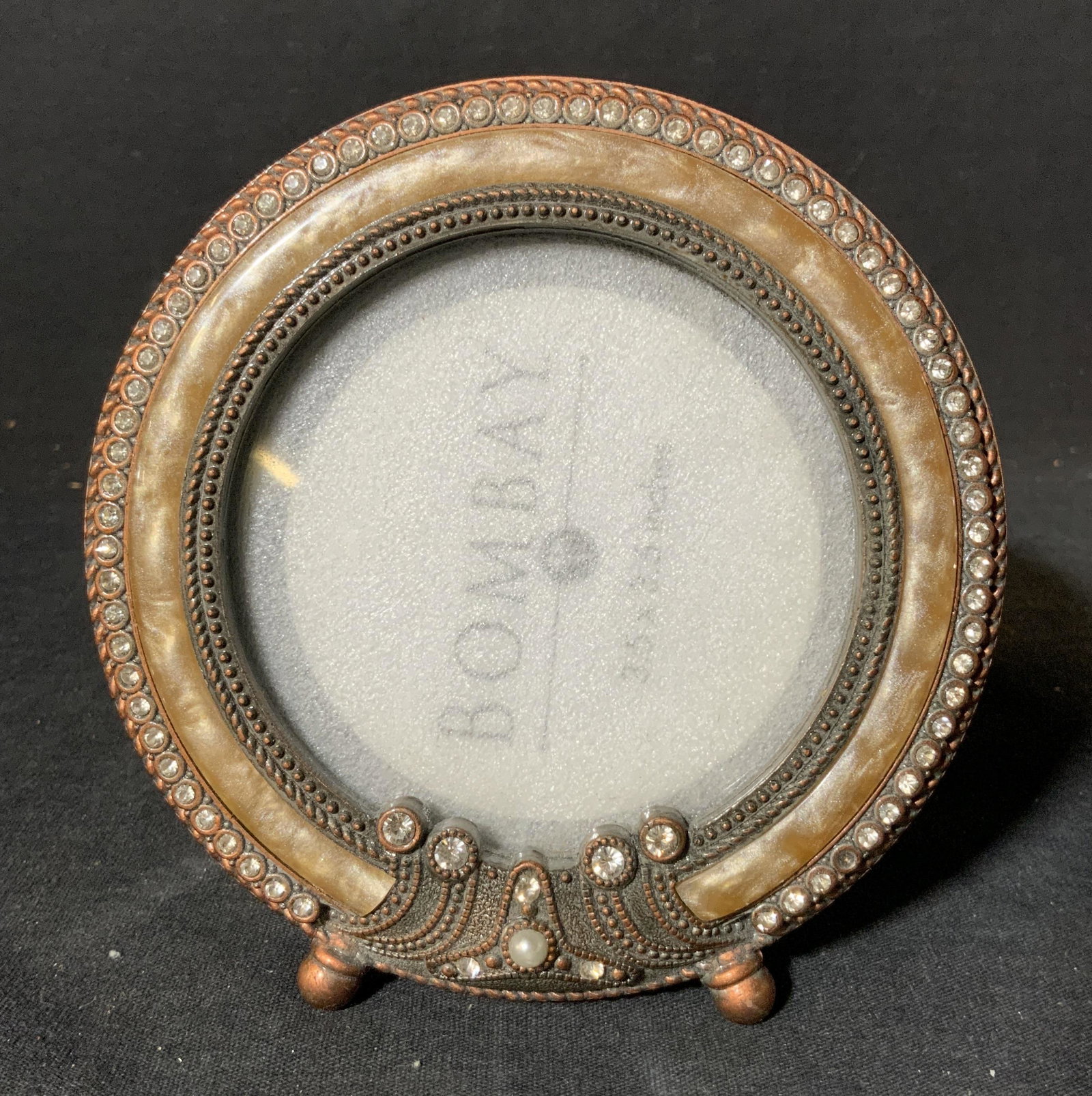 BOMBAY Rhinestoned Picture Frame: BOMBAY Rhinestoned Picture Frame, inscriptions read ‘Bombay 3.5 x 3.5 inches, measures 4 3/4 inches in diameter, surface wear to piece, Bombay, picture frame, photography, photo frame, decorative fr