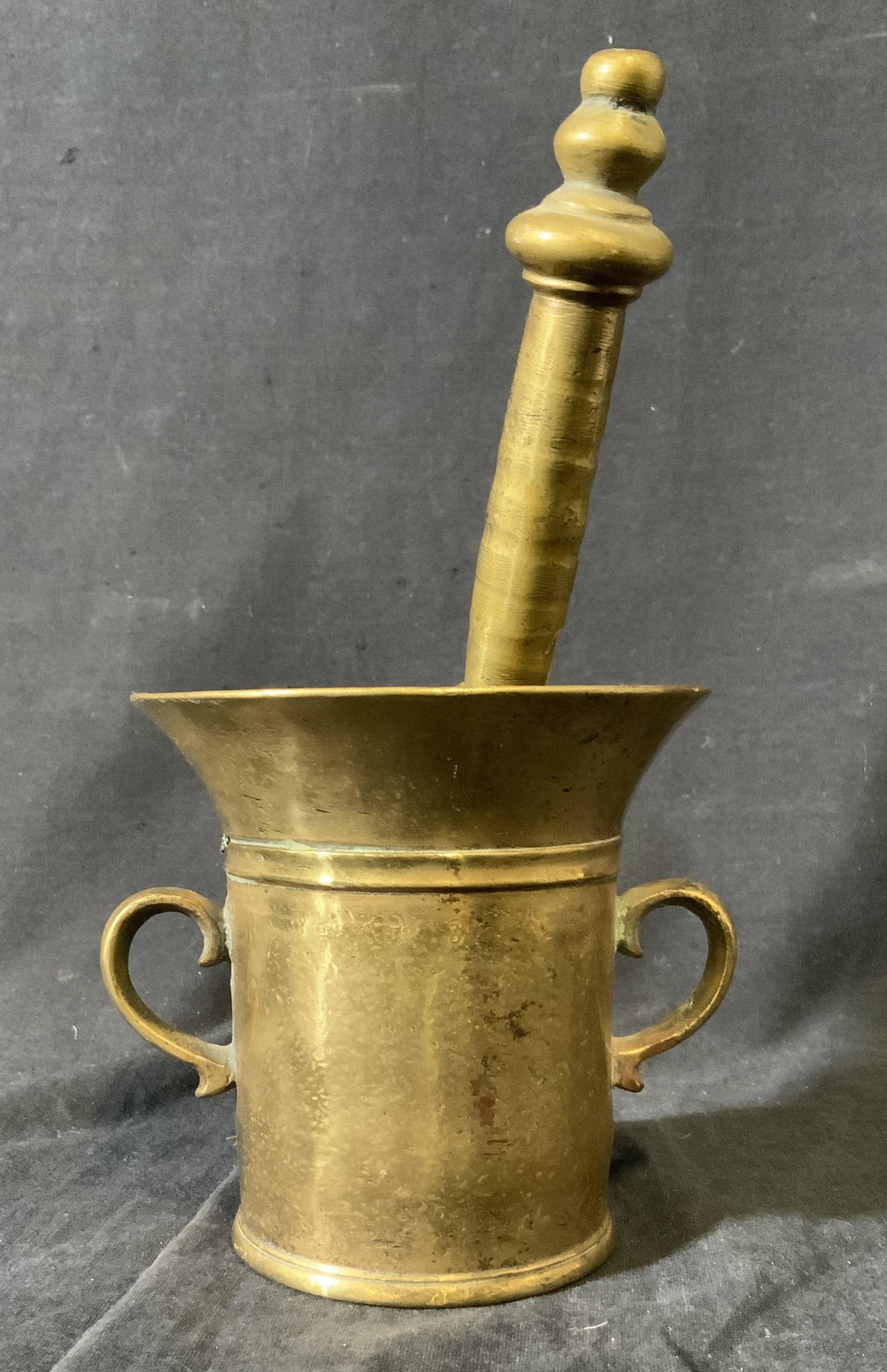 Brass Pestle and Handled Mortar: Brass Pestle and Handled Mortar, no apparent inscriptions or markings, mortar measures 4 1/2 inches tall x 4 5/8 inches in diameter at widest point, pestle measures 8 5/8 inches in length x 1 3/4 in w