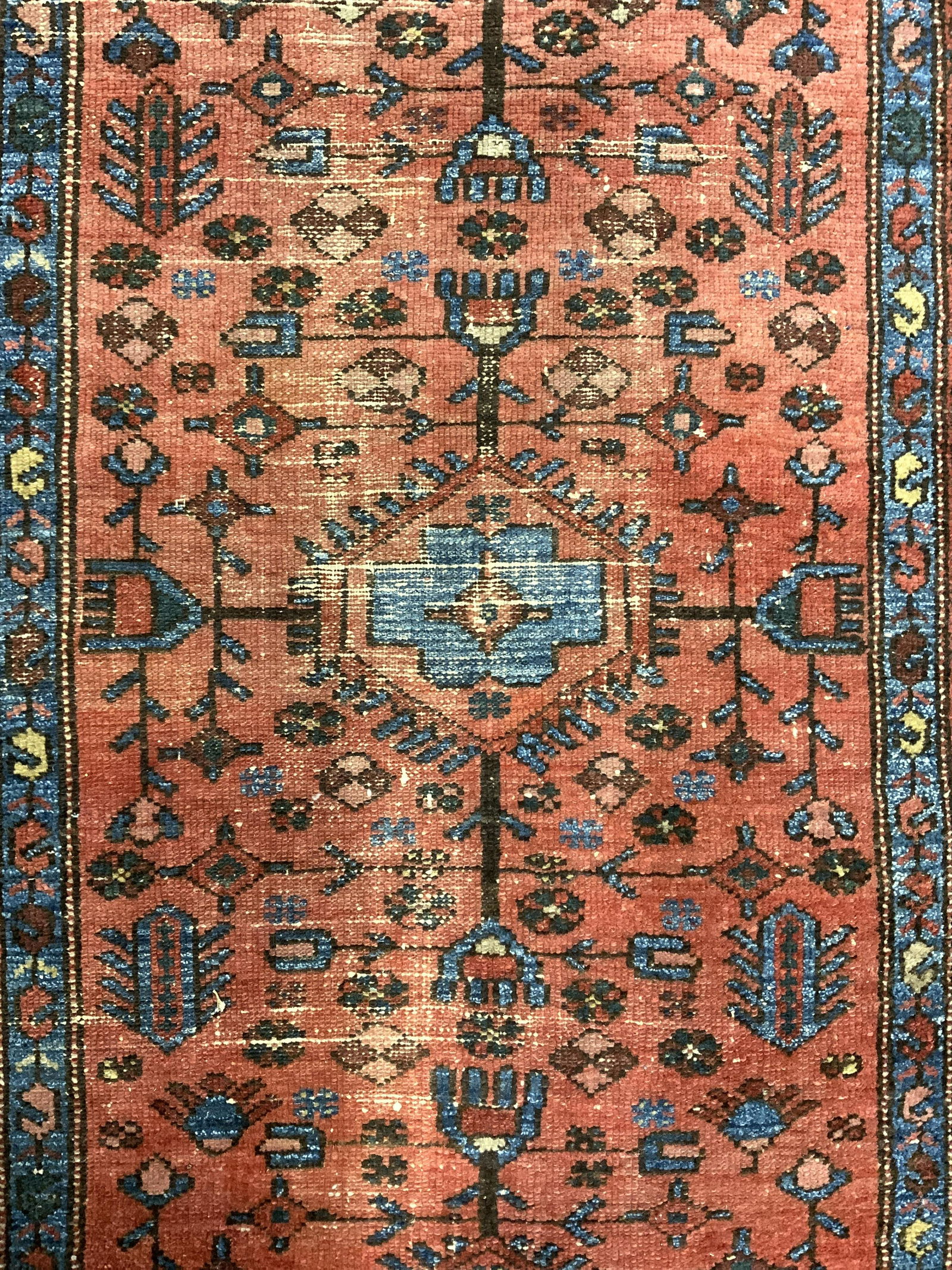 Vintage Handmade Persian Wool Area Rug: Rug is wool and handmade. Piece is vintage possibly antique. Rug contains intricate multi toned floral, vine, leaf & geometric detail. Piece measures approx 64 inches long 39 inches wide . Rug, carpet