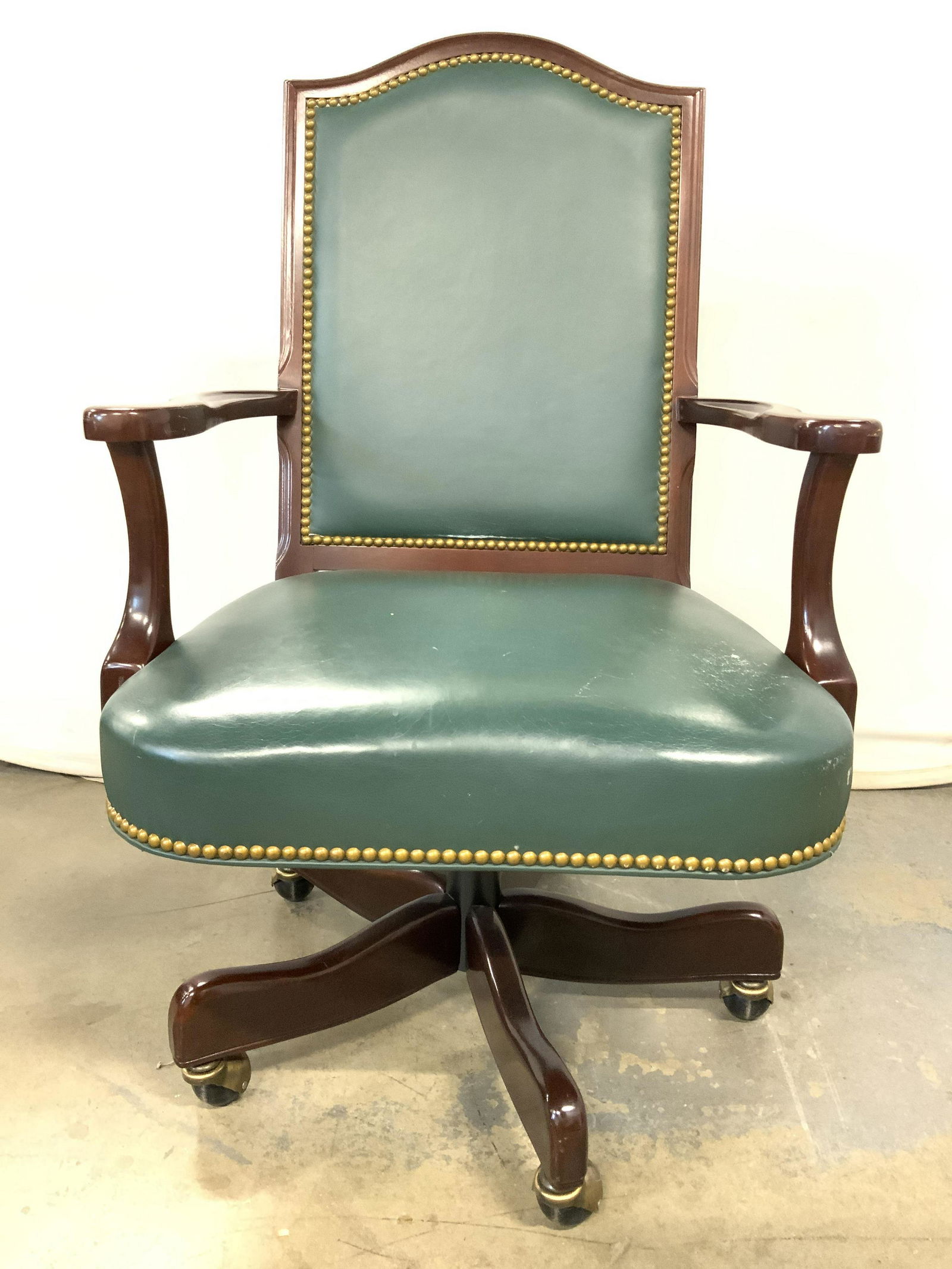 HANCOCK & MOORE Wood & Leather Office Chair: Underside of piece has tag which reads HANCOCK & MOORE. Piece has wooden frame, possibly mahogany. Backrest & seat have green toned upholstery appears to possibly be genuine leather. Edges of upholste