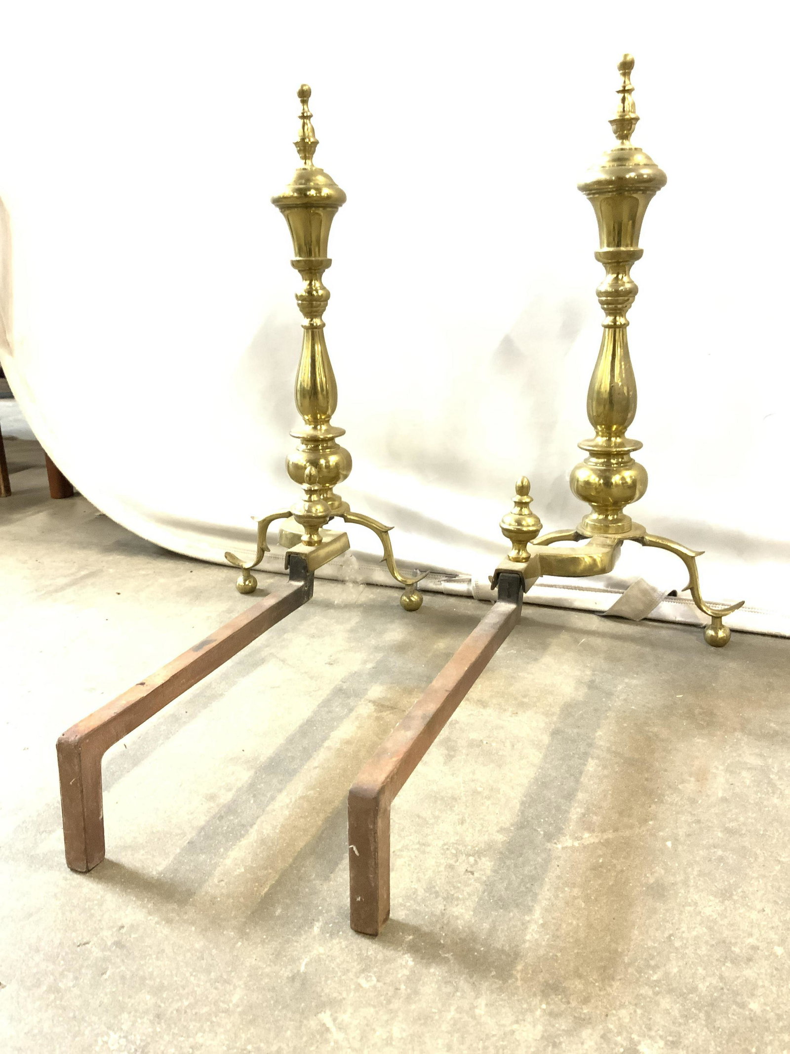 Vintage Gold Toned Brass Andirons: Andirons are gold toned and brass. Each piece is vintage possibly antique. Each piece has 2 spherical shaped feet. Andirons, vintage andirons, brass andirons, fireplace decor, fireplace andirons. Each