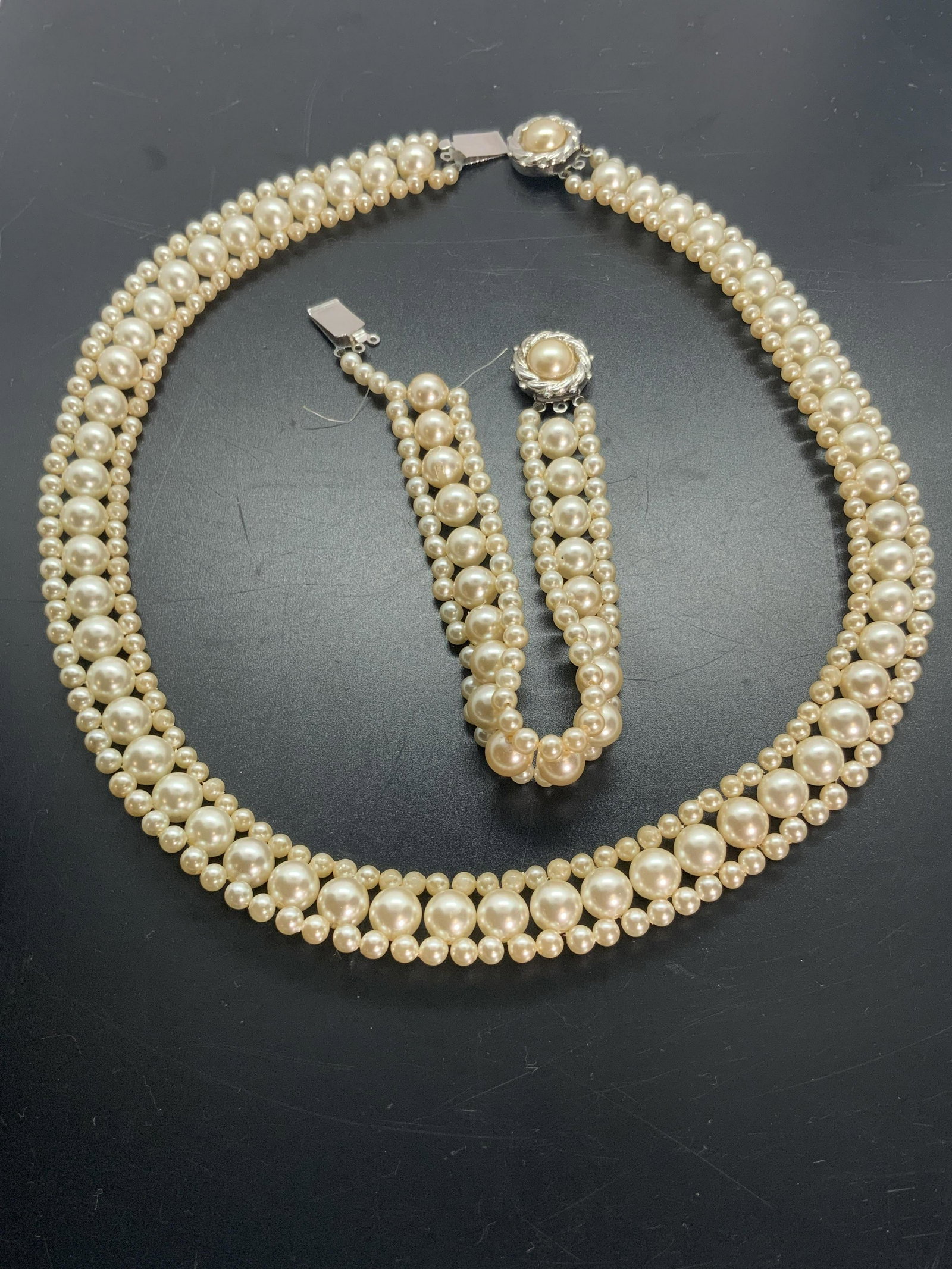 Set Vintage Pearlescent Bracelet & Necklace: A vintage set of pearlescent jewelry that includes a bracelet and a necklace. Pearlescent beads are strung on colorless cord. Pieces are large and small spheres covered with pearlescent coating. Clasp